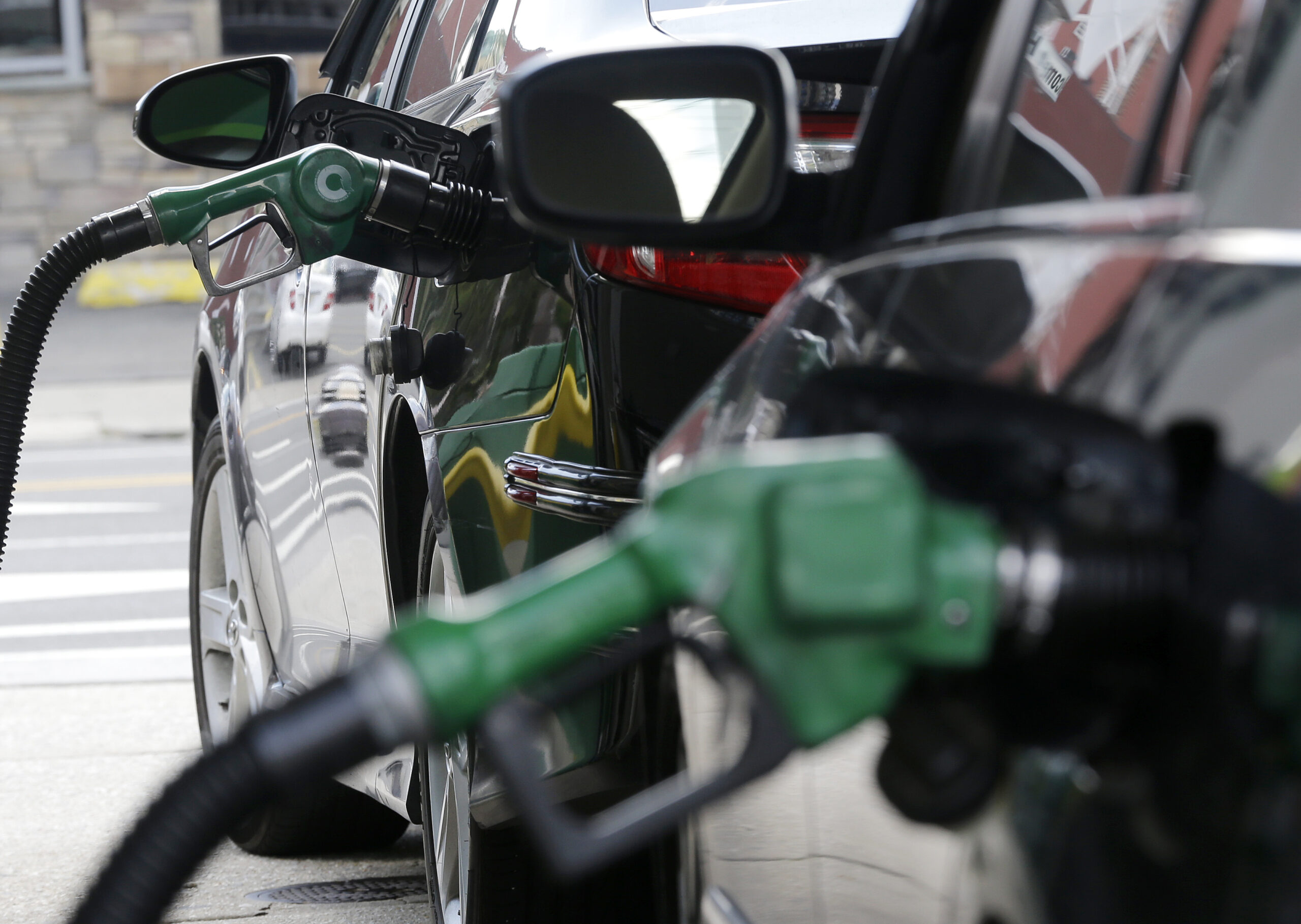 FILE - In this June 30, 2016, file photo, gas is pumped into vehicles at a BP gas station in Hoboken, N.J. The Obama administration has decided not to change government fuel economy requirements for cars and light trucks despite protests from automakers. (AP Photo/Julio Cortez, File) (AP)