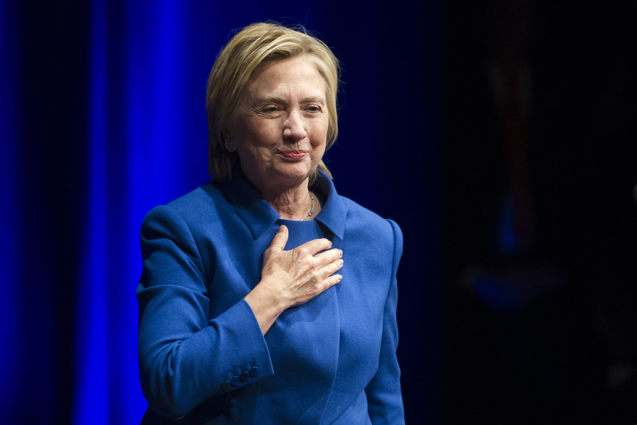 Hillary Clinton places her hand over her hand as she walks to the podium to address the Children's Defense Fund's Beat the Odds celebration at the Newseum in Washington, Wednesday, Nov. 16, 2016. (AP)