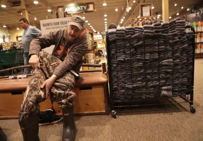 Matt Little, of St. Charles, Mo., tries on duck waders at Cabella's in Hazelwood, Mo., on Black Friday, Nov. 25, 2016. (Christian Gooden/St. Louis Post-Dispatch via AP) (AP)