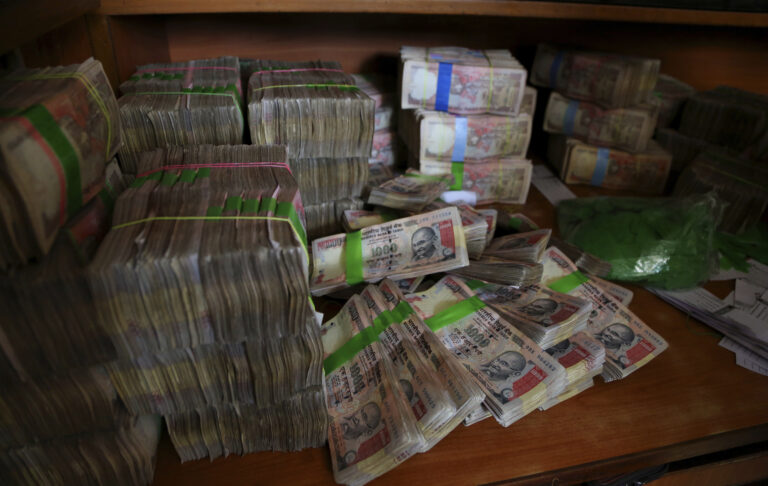 FILE - In this Nov. 10, 2016 file photo, discontinued Indian currency notes of 1,000 denomination are seen after they were deposited by people at a bank in Bangalore, India. Indian prime minister Narendra Modi, in his Nov. 8 televised address, announced the demonetization of India’s 500 and 1,000-rupee notes, which made up 86 percent of the country’s currency. There are doubts about whether the demonetization drive will truly make an impact on corruption and tax evasion. India’s underground economy is so big it accounts for up to a quarter of the country’s gross domestic product. And many of those possessing piles of black money have come up with ways to save much of it without drawing government attention. (AP)