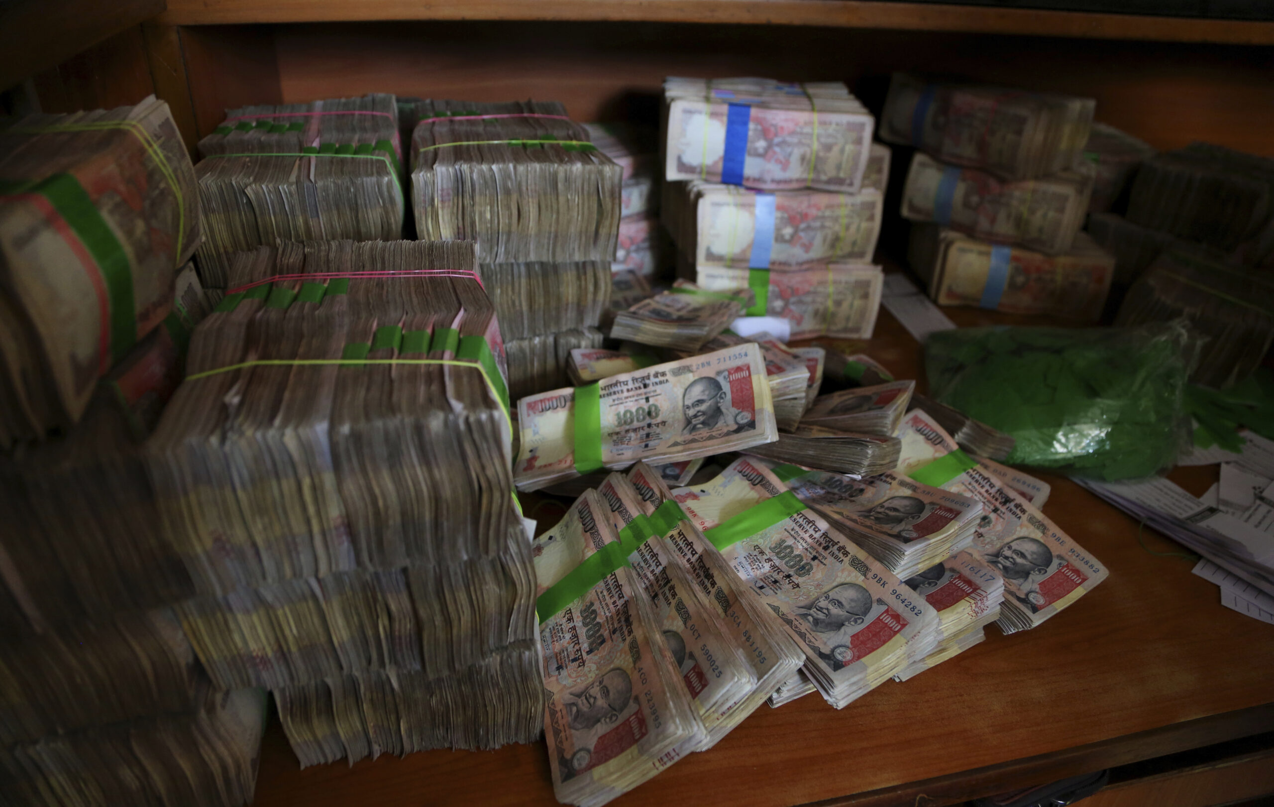 FILE - In this Nov. 10, 2016 file photo, discontinued Indian currency notes of 1,000 denomination are seen after they were deposited by people at a bank in Bangalore, India. Indian prime minister Narendra Modi, in his Nov. 8 televised address, announced the demonetization of India’s 500 and 1,000-rupee notes, which made up 86 percent of the country’s currency. There are doubts about whether the demonetization drive will truly make an impact on corruption and tax evasion. India’s underground economy is so big it accounts for up to a quarter of the country’s gross domestic product. And many of those possessing piles of black money have come up with ways to save much of it without drawing government attention. (AP)