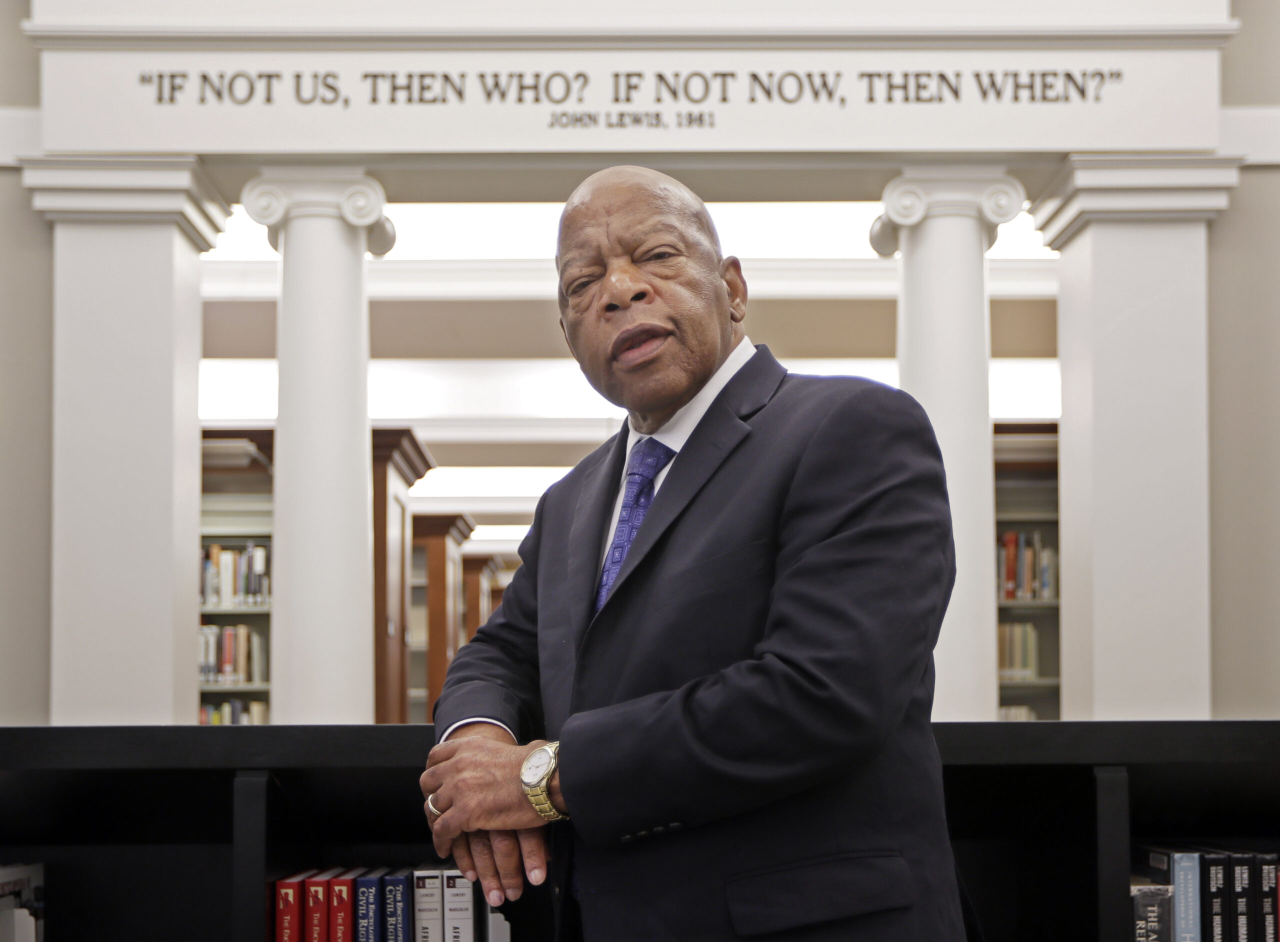 Rep. John Lewis, D-Ga., poses for a photograph under a quote of his that is displayed in the Civil Rights Room in the Nashville Public Library Friday, Nov. 18, 2016, in Nashville, Tenn. (AP)