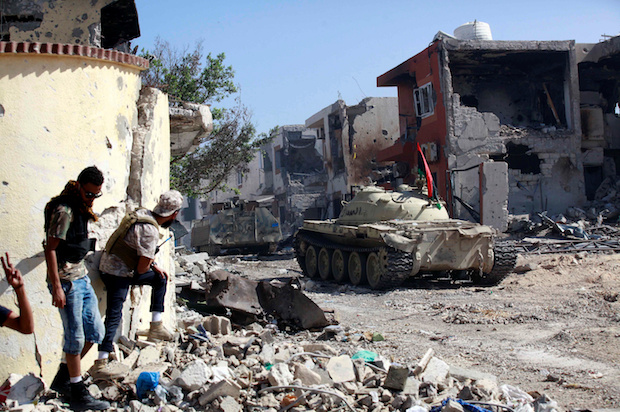 Fighters of Libyan forces allied with the U.N.-backed government take cover during a battle with Islamic State militants in Ghiza Bahriya district in Sirte, Libya, on October 31, 2016 (Reuters/Hani Amara)