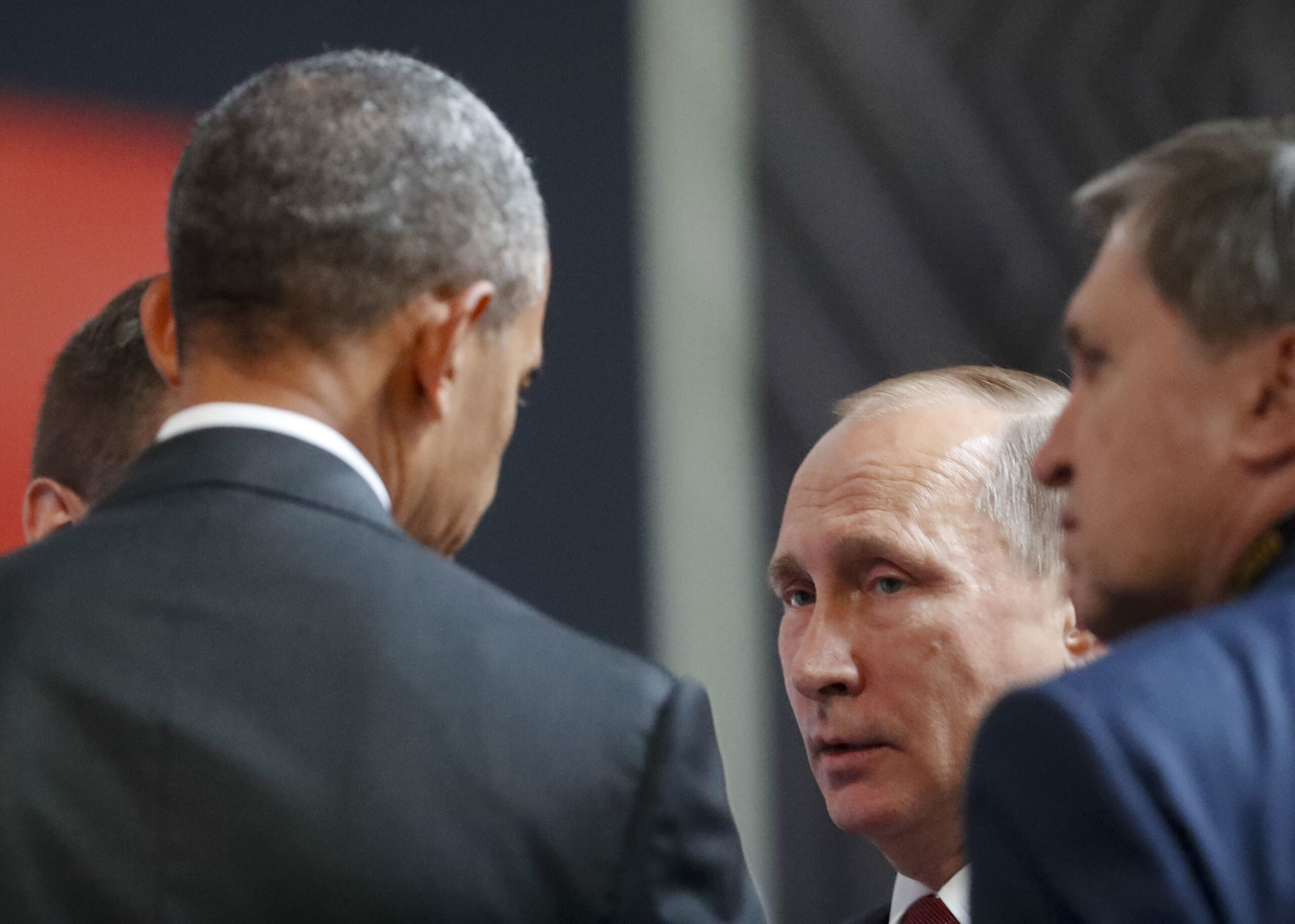 U.S. President Barack Obama, left, talks with Russia's President Vladimir Putin, right, at the opening session of the Asia-Pacific Economic Cooperation (APEC) in Lima, Peru, Sunday, Nov. 20, 2016. (AP Photo/Pablo Martinez Monsivais) (AP)