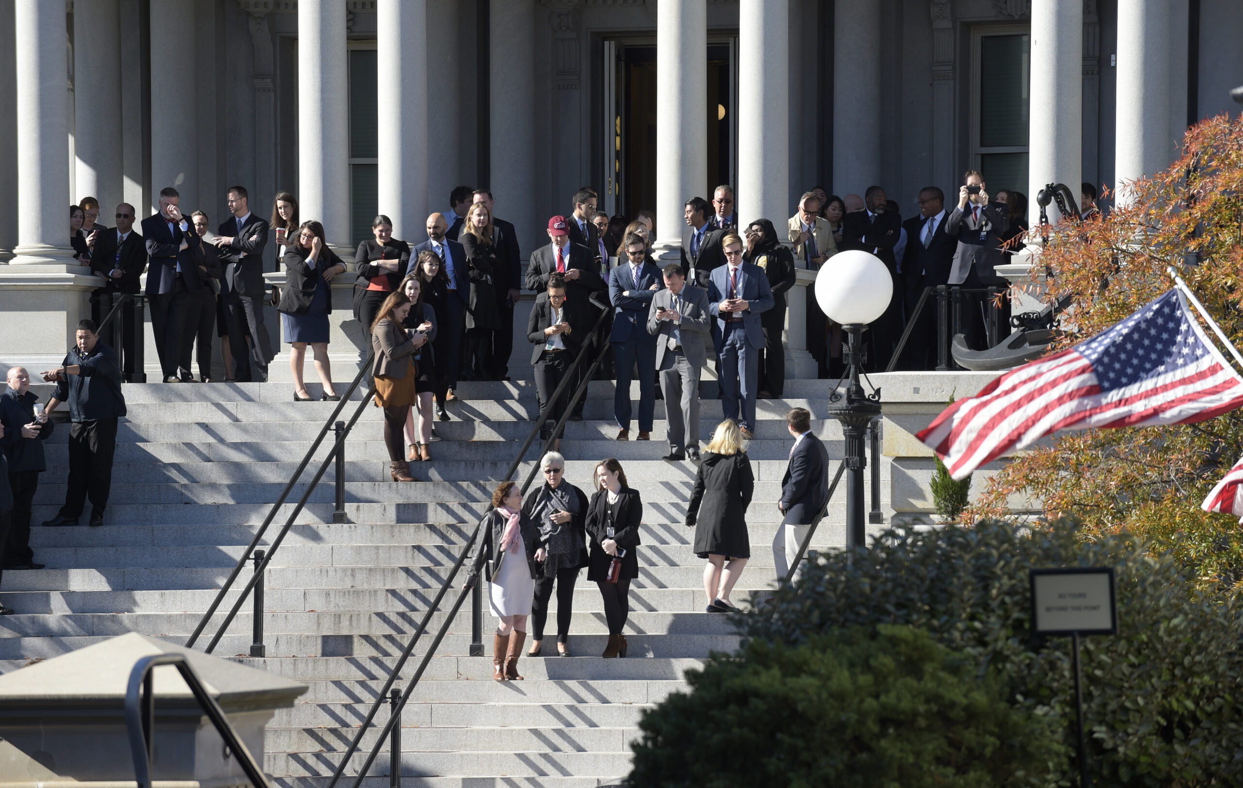 People stand on the steps of the Eisenhower Executive Office Building, next to the White House in Washington, Thursday, Nov. 10, 2016, as they wait for the arrival of President-elect Donald Trump for his meeting with President Barack Obama. (AP Photo/Susan Walsh) (AP)