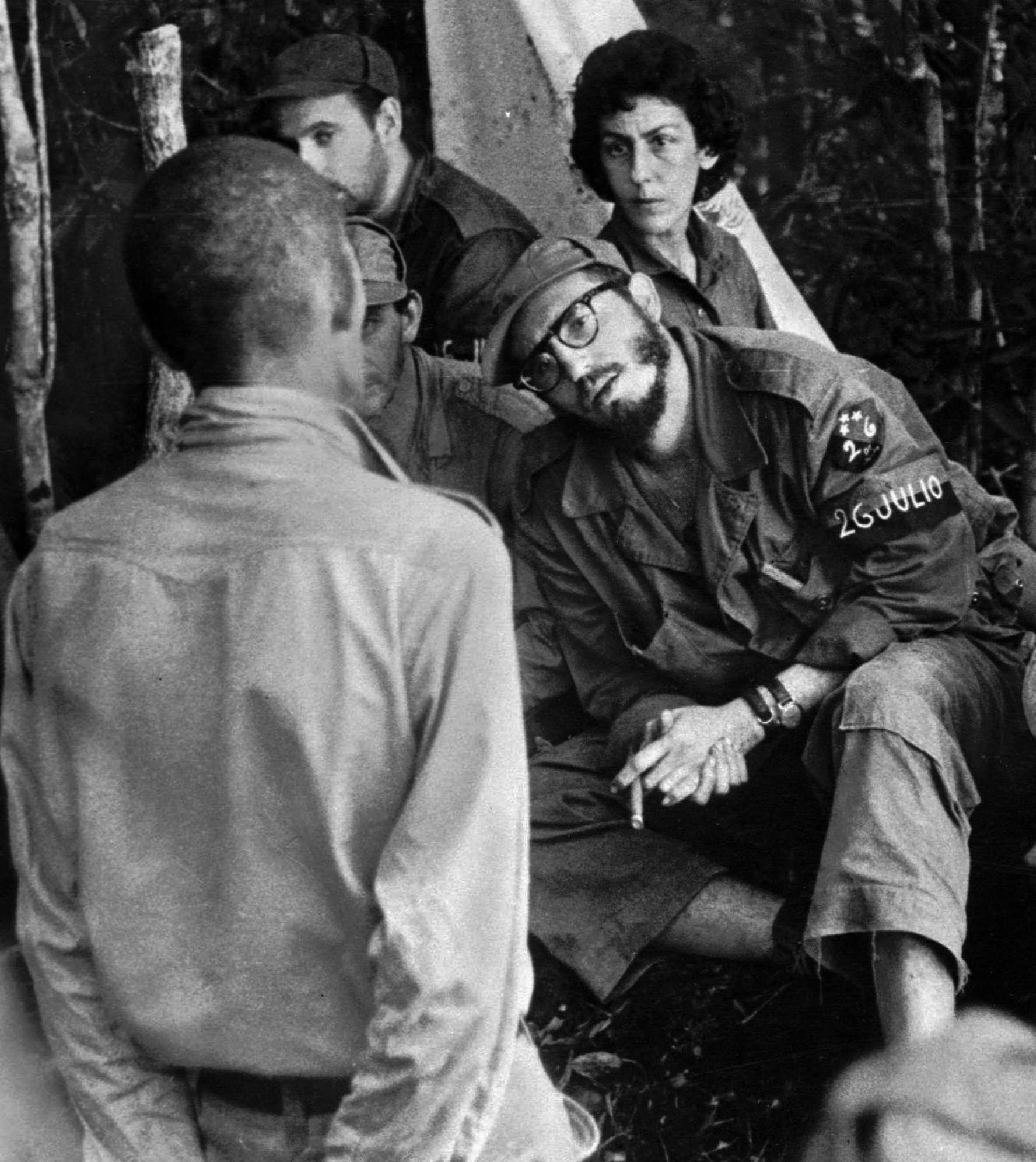 FILE - In this 1958 file photo, Cuba's leader Fidel Castro, center, questions a man charged with banditry as Celia Sanchez looks on during a trial held in the guerrillas' base in the Cuban mountain range of Sierra Maestra. (AP)