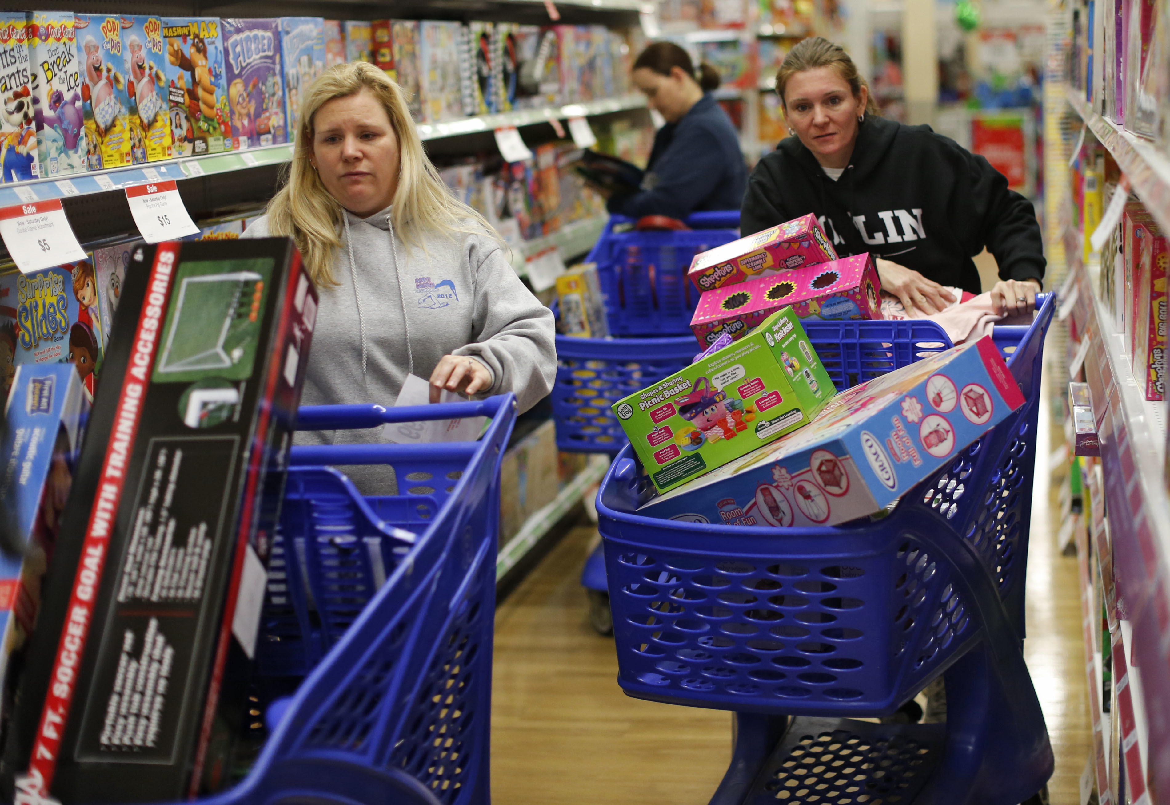 FILE - In this Friday, Nov. 27, 2015, file photo, cousins Stacy Levine, left, and Melissa Bragg shop at a Toys R Us store in Atlanta on Black Friday. ((Bob Andres/Atlanta Journal-Constitution via AP, File))