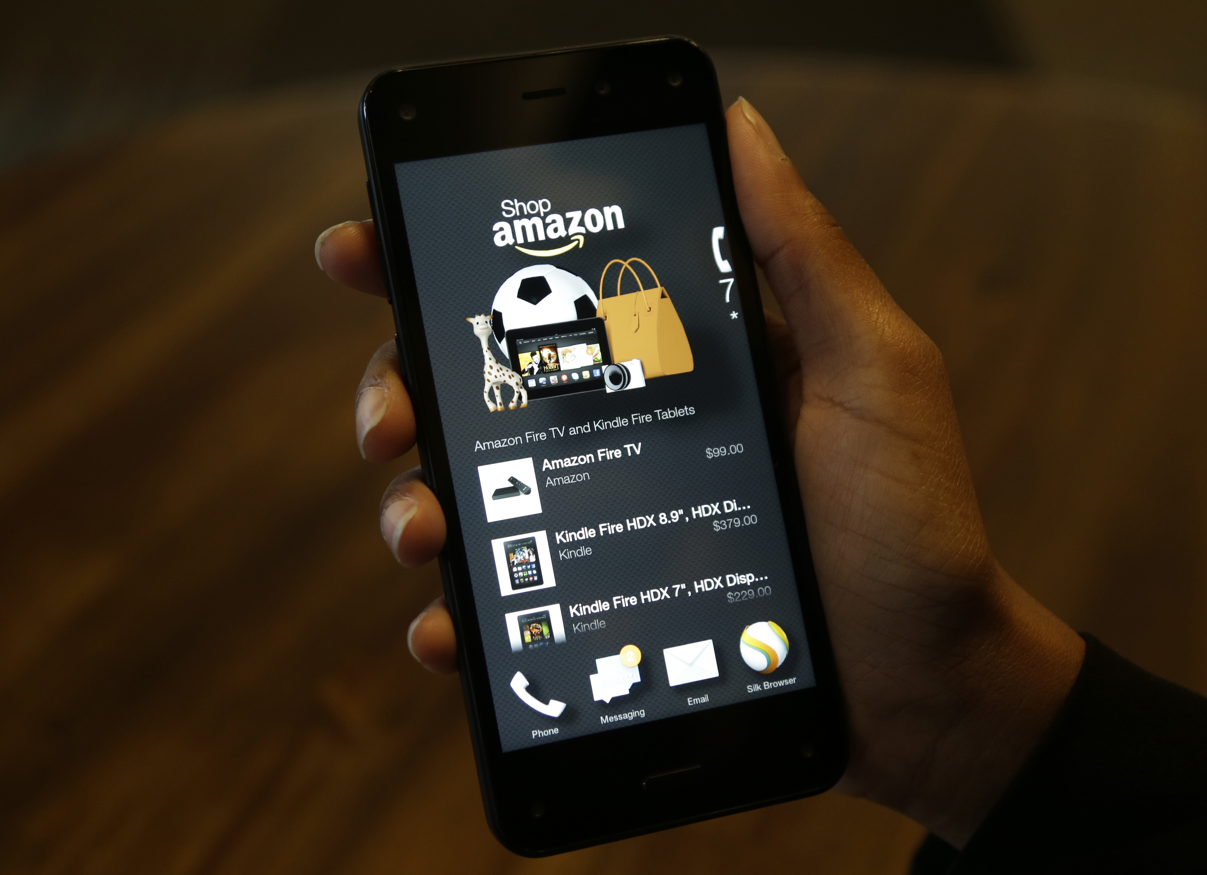 FILE - This June 18, 2014, file photo shows the app that links to shopping on Amazon.com on an Amazon Fire Phone, in Seattle. If you’re looking to save a few bucks at the mall, there are apps available that can help find you coupons, compare prices or price match. (AP Photo/Ted S. Warren, File) (AP)