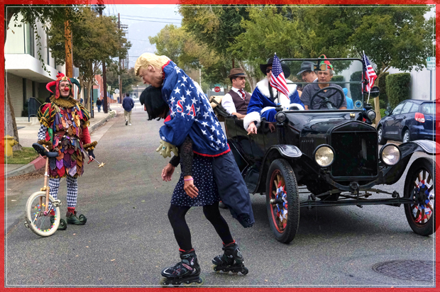 A roller skater carrying an effigy of President elect Donald Trump draped in an American flag rides down the street prior to participating in the 39th Occasional Pasadena Doo Dah Parade on Sunday, Nov. 20, 2016 in Pasadena, Calif.  (AP Photo/Richard Vogel) (AP)