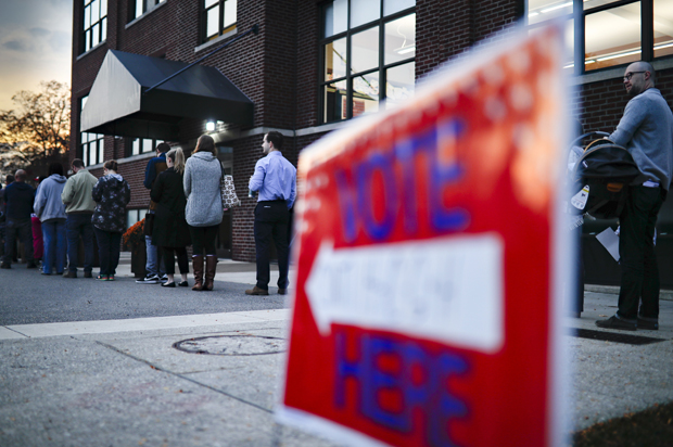 Voters wait in line outside a polling place in Cincinnati (AP/John Minchillo)