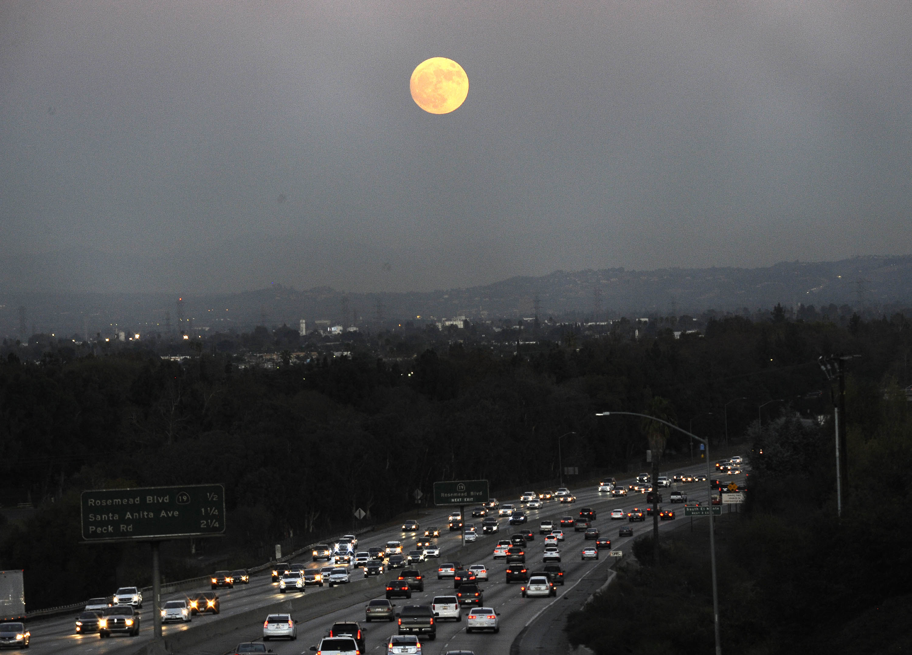 The moon rises above California 60 on Sunday, Nov. 13, 2016, in Rosemead, Calif. (AP)