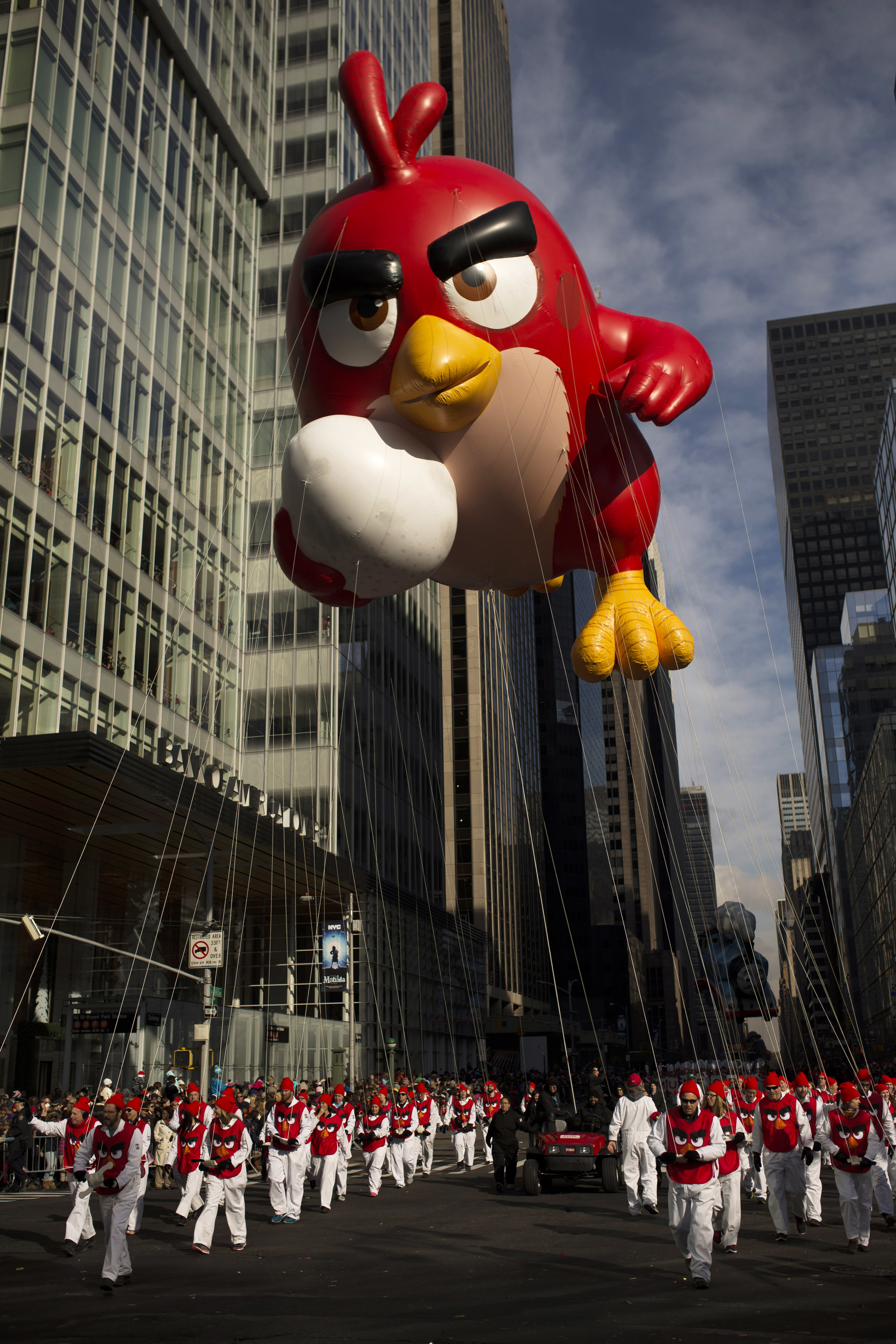FILE - In this Thursday, Nov. 26, 2015, file photo, the balloon Angry Bird is moved through Sixth Avenue during the Macy's Thanksgiving Day Parade in New York. A giant Charlie Brown balloon will join 1,000 clowns and a dozen marching bands along a parade route lined with spectators and police in plainclothes for the 90th annual parade. (AP Photo/Andres Kudacki, File) (AP)