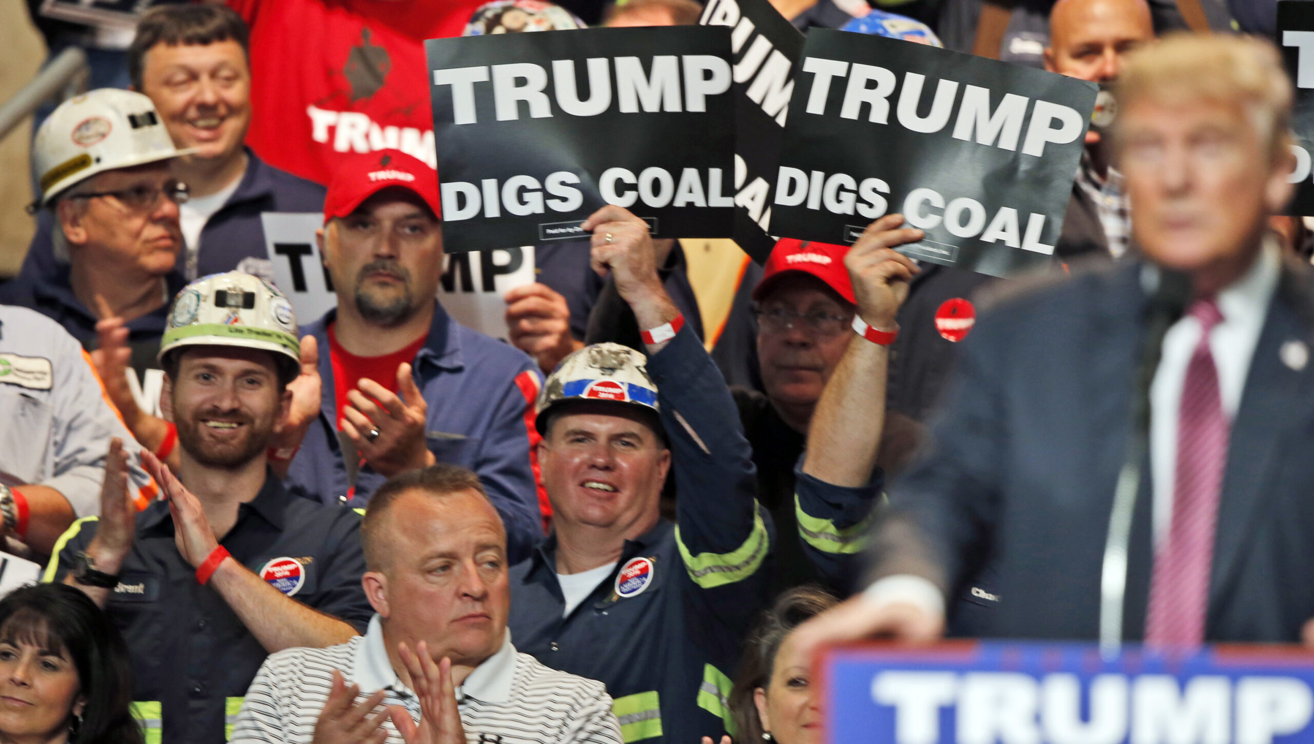 FILE- In this May 5, 2016 photo, Coal miners wave signs as Republican presidential candidate Donald Trump speaks during a rally in Charleston, W.Va. Trump's election could signal the end of many of President Barack Obama's signature environmental initiatives. Trump has said he loathes regulation and wants to use more coal and expand offshore drilling and hydraulic fracturing. (AP Photo/Steve Helber, File) (AP)