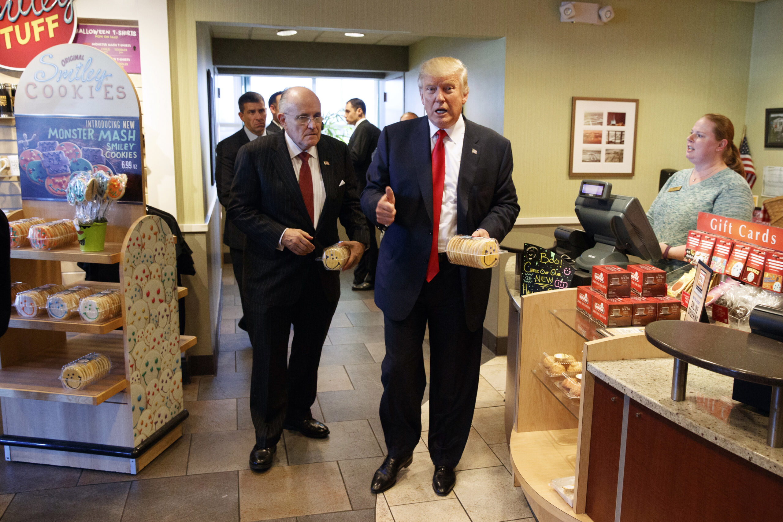 FILE - In this Oct. 10, 2016, file photo, former New York mayor Rudy Giuliani, left, stands with then-Republican presidential candidate Donald Trump as he buys cookies during a visit to Eat'n Park restaurant in Moon Township, Pa. (AP)