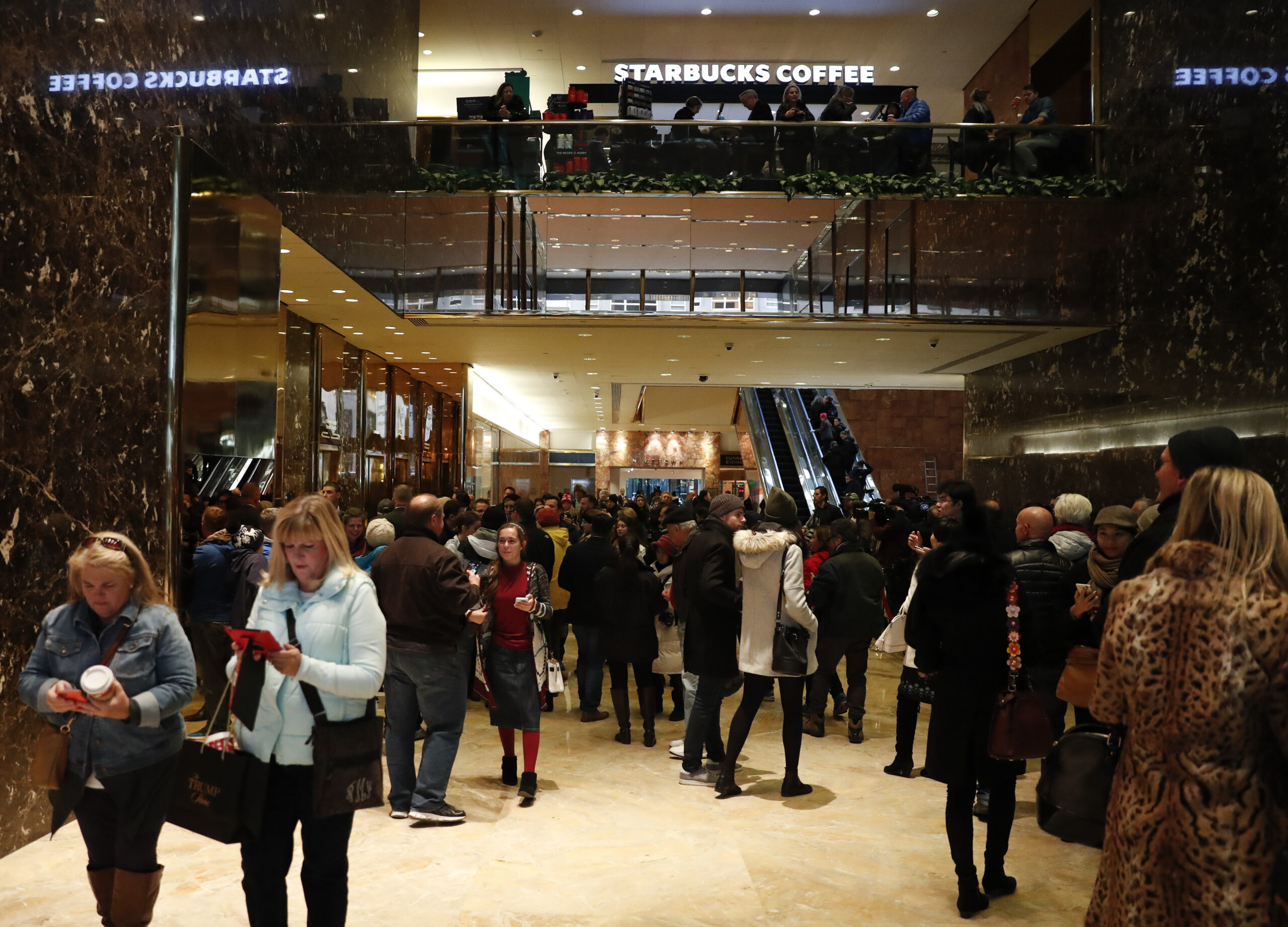 Tourists, pedestrians and security gather in the lobby of Trump Tower in New York, Monday, Nov. 21, 2016. (AP)