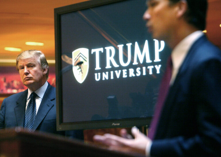 In May 23, 2005, Donald Trump, left, listens as Michael Sexton introduces him at a   conference where he announces the establishment of Trump University. (AP Photo/Bebeto Matthews)
