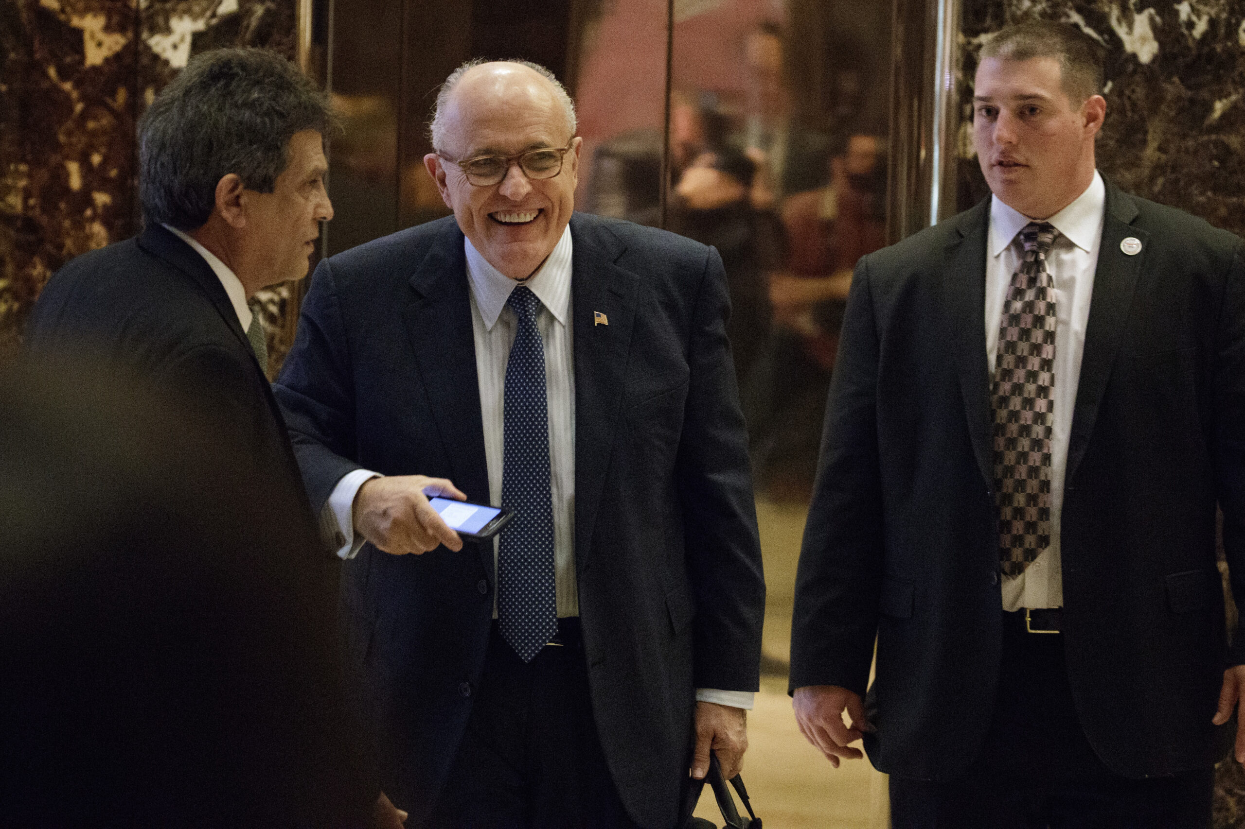 Former New York Mayor Rudy Giuliani, center, smiles as he leaves Trump Tower, Friday, Nov. 11, 2016, in New York. (AP Photo/Evan Vucci) (AP)
