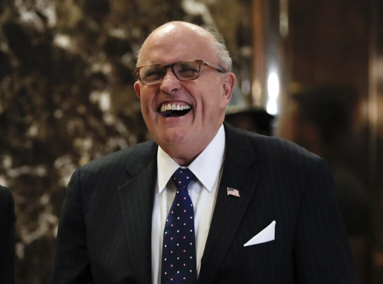 Former New York Mayor Rudy Giuliani laughs as he arrives at Trump Tower, Wednesday, Nov. 16, 2016, in New York. (AP)