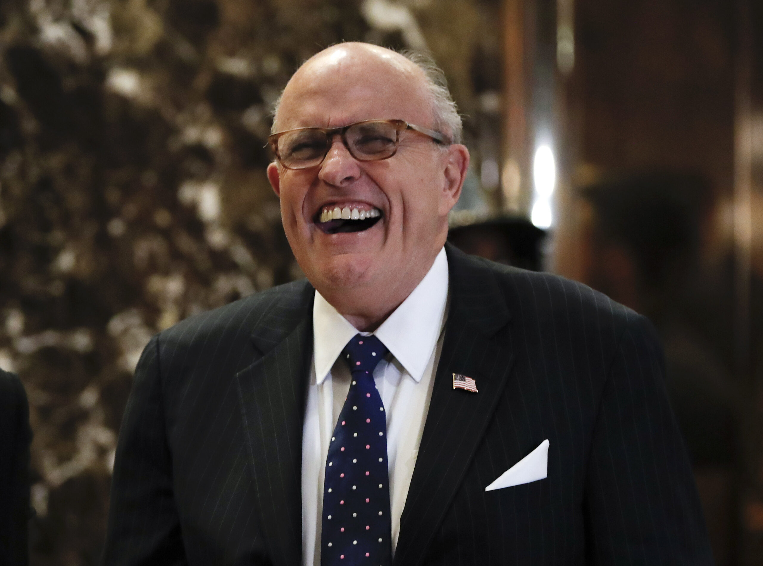 Former New York Mayor Rudy Giuliani laughs as he arrives at Trump Tower, Wednesday, Nov. 16, 2016, in New York. (AP)