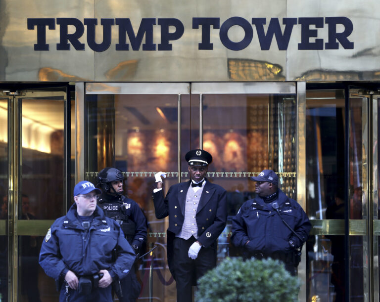A doorman, center, talks with security personnel at the front entrance of Trump Tower in New York, Thursday, Nov. 17, 2016. (AP)