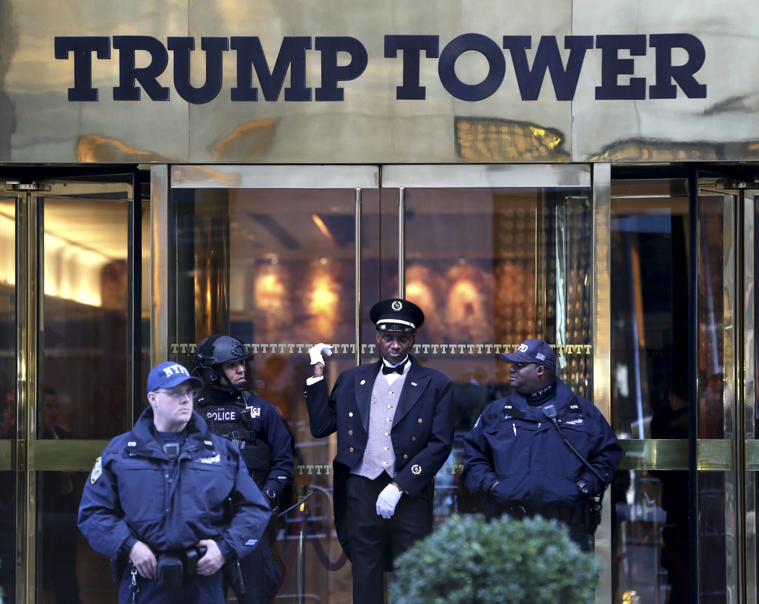 A doorman, center, talks with security personnel at the front entrance of Trump Tower in New York, Thursday, Nov. 17, 2016. (AP)