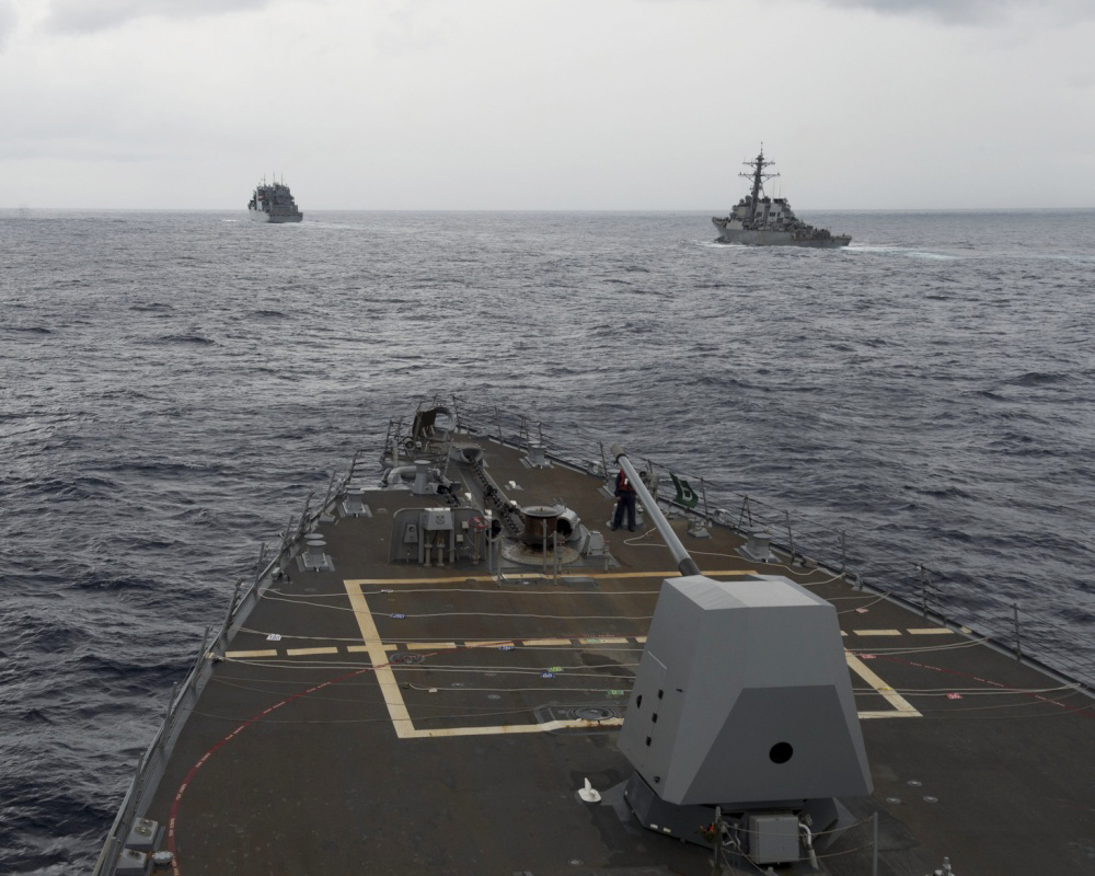FILE - This Oct. 17, 2016 file image provided by the U.S. Navy,  shows the guided missile destroyer USS Decatur, right, pulling into position behind the Military Sealift Command USNS Matthew Perry, during a replenishment-at-sea, seen from the bridge of the guided-missile destroyer USS Spruance, in the South China Sea. The commander of U.S. forces in the Pacific Adm. Harry Harris said he’s concerned with China’s assertiveness in the South China Sea and the East China Sea as he headed to the Philippines to discuss the next round of joint exercises. (U.S. Navy/Petty Officer 2nd Class Will Gaskill via AP, File) (AP)
