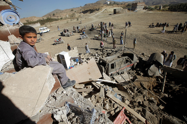 A Yemeni boy sits on the wreckage of a house destroyed by a U.S.-backed, Saudi-led airstrike on the outskirts of Sanaa, Yemen, November 13, 2016 (Reuters/Mohamed al-Sayaghi)