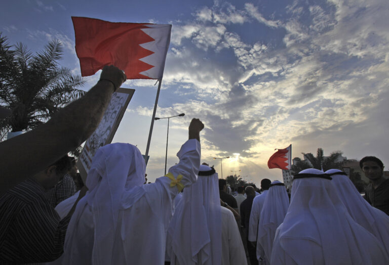 FILE- In this Friday, March 21, 2014 file photo, Bahraini pro-democracy protesters wave signs and pictures of prisoners and people killed in three years of unrest as well as national flags during a march in Abu Saiba, west of the capital of Manama, Bahrain. In Bahrain, people are outraged over the shooting death of a 28-year-old woman in front of her 6-year-old, which activists say was carried out by a royal family member in December 2016. The accusation goes to the heart of lingering unrest on the island off the coast of Saudi Arabia, now five years on from its Arab Spring protests and in the grips of a renewed government crackdown on dissent. (AP Photo/Hasan Jamali, File) (AP)