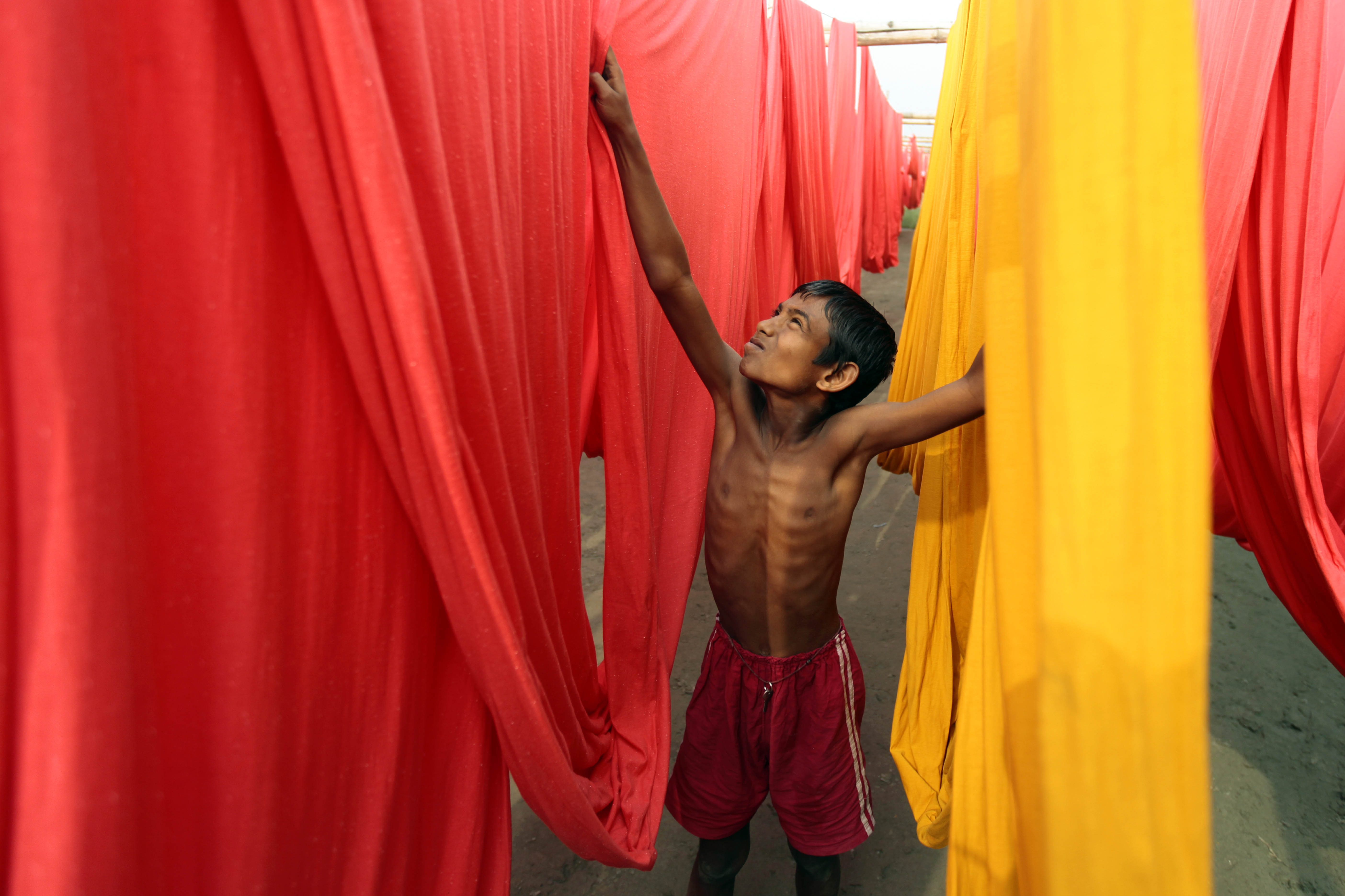FILE- In this Saturday, Dec. 22, 2012 file photo, a Bangladeshi child works at a clothes-dyeing factory in Narayanganj, outskirts of Dhaka, Bangladesh. A new study by the London-based Overseas Development Institute found that thousands of Bangladeshi children who live in the capital's slums are working illegally for an average of 64 hours a week. (AP Photo/A.M. Ahad, File) (AP)