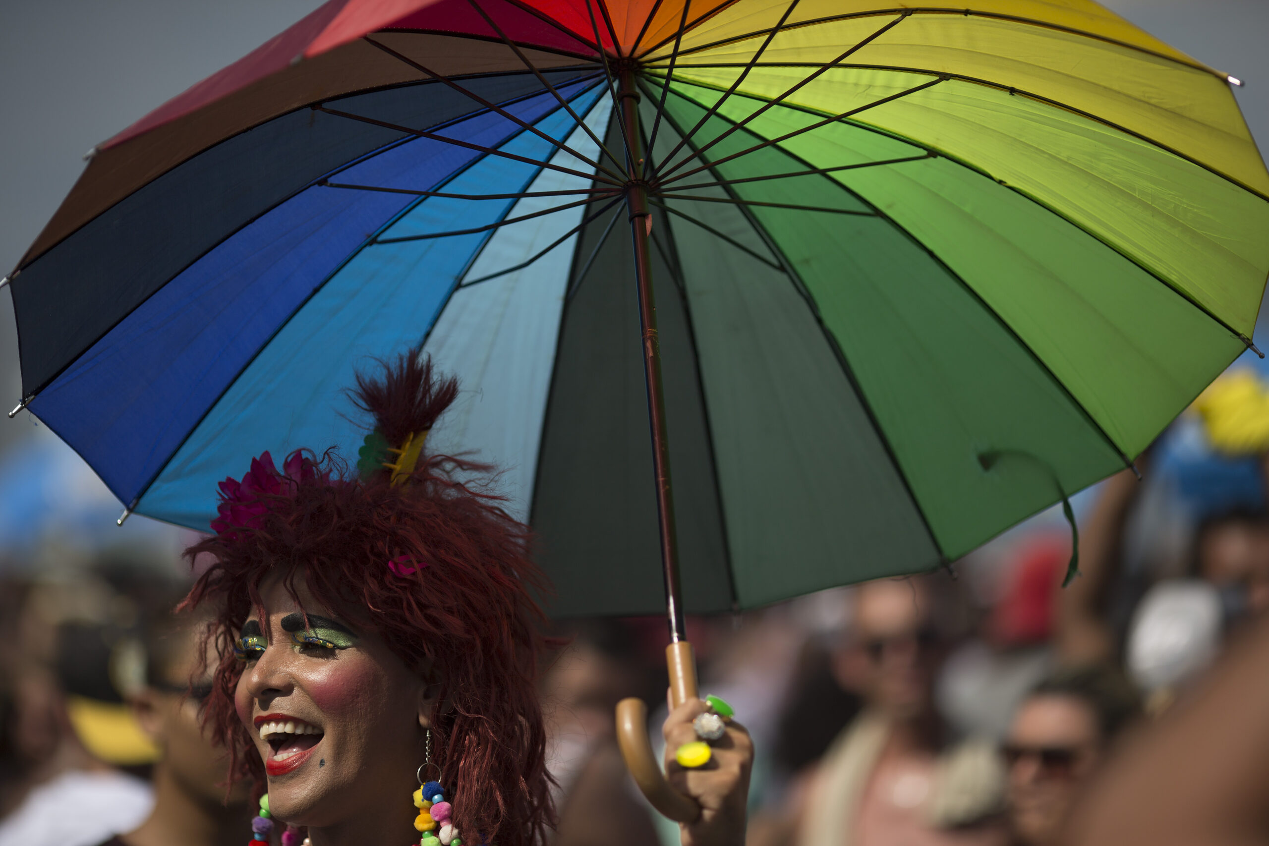 A man holds a colored umbrella as he participates in the Gay Pride Parade at Copacabana beach in Rio de Janeiro, Brazil, Sunday, Dec. 11, 2016. People took part in Rio de Janeiro's 21st Gay Pride Parade to fight for more justice and an inclusive society which recognizes equal rights for the gay community. (AP Photo/Leo Correa) (AP)