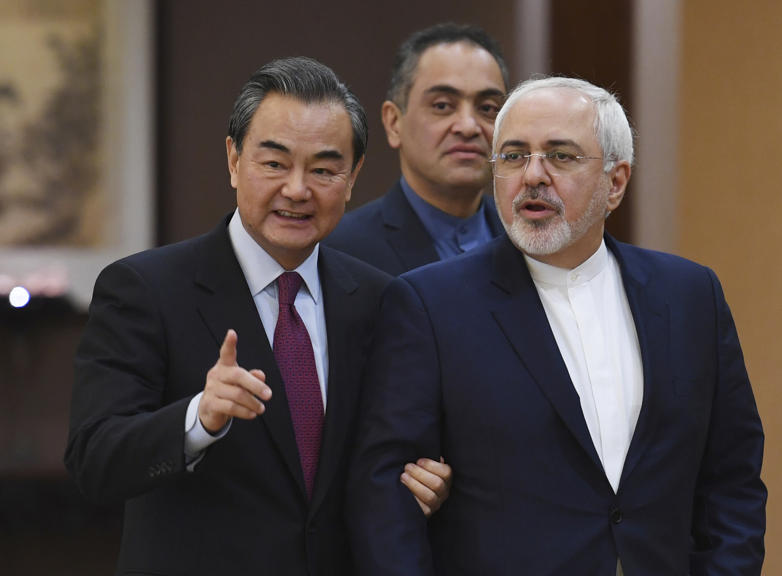 Iranian Foreign Minister Mohammad Javad Zarif, right, arrives with Chinese Foreign Minister Wang Yi for a joint press conference in Beijing Monday, Dec. 5, 2016. (Greg Baker/Pool Photo via AP) (AP)