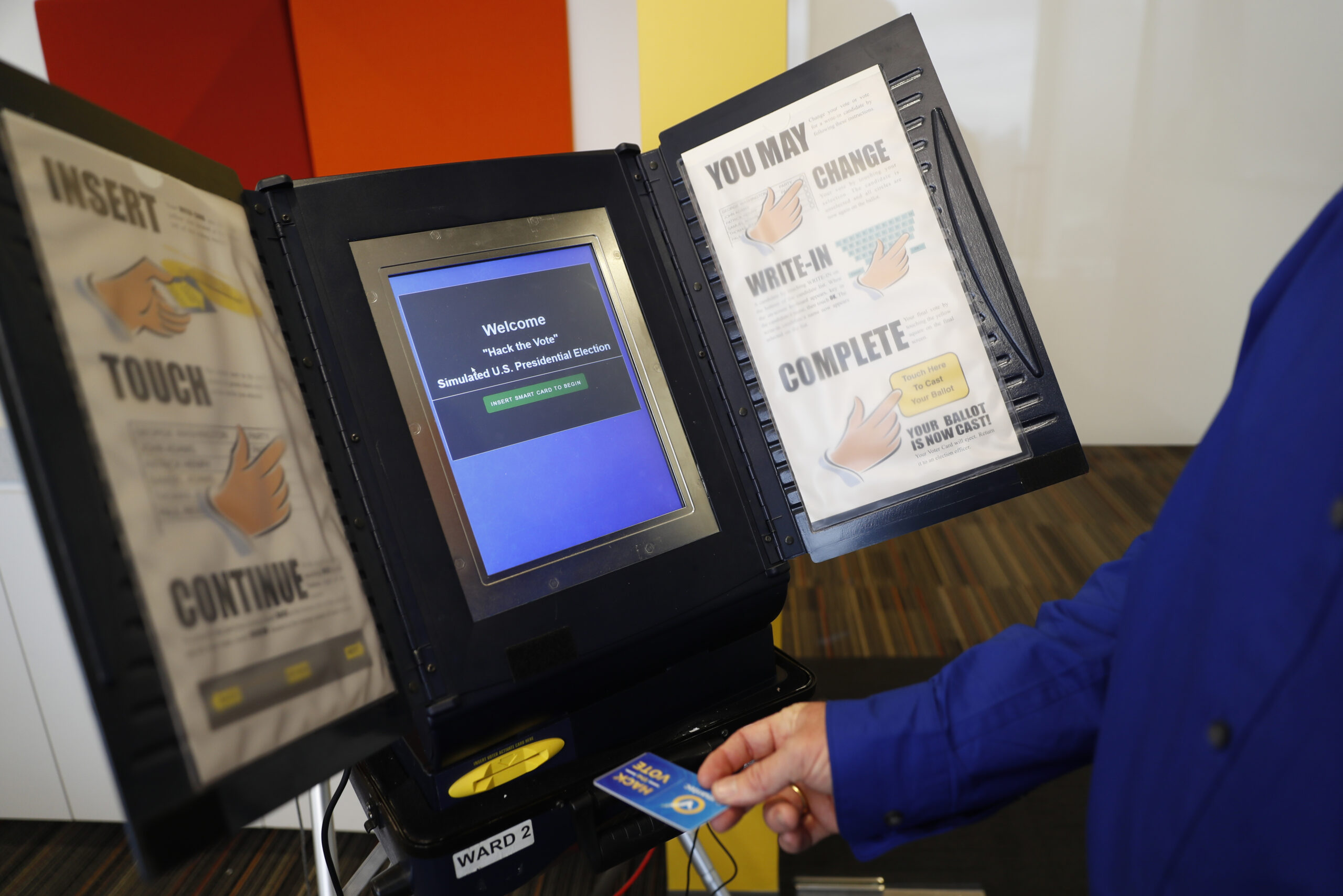 FILE - In this Wednesday, Sept. 28, 2016 file photo, Brian Varner, a principal researcher at Symantec, inserts an identifying chip card into an electronic voting machine as he demonstrates how to hack an electronic voting machine at a Symantec office in New York. The U.S. voting system, a loosely regulated, locally managed patchwork of more than 3,000 jurisdictions overseen by the states, employs more than two dozen types of machinery from 15 manufacturers. Elections officials across the nation say they take great care to secure their machines from tampering. (AP Photo/Mary Altaffer, File) (AP)