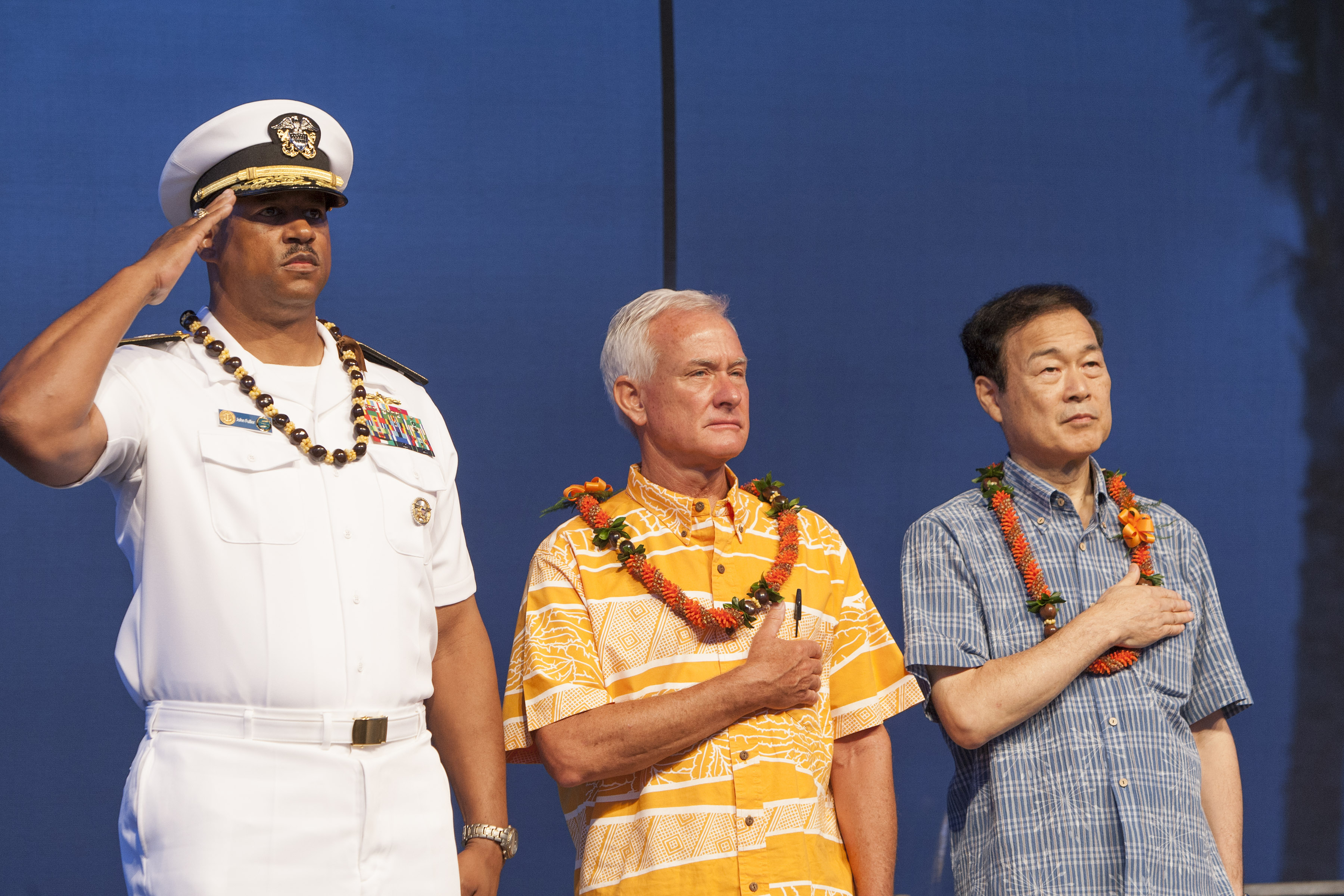 FILE - In this Aug. 15, 2015 file photo, U.S. Navy Read Adm. John Fuller, left, Honolulu mayor Kirk Caldwell, center, and then Nagaoka CityMayor Tomio Mori look on during a celebration marking the 70th anniversary of the end of World War II at Joint Base Pearl Harbor-Hickam, in Honolulu. The mayor of Nagaoka, Japan, the birthplace of the man who engineered the Pearl Harbor attack, is joining his counterpart of Honolulu to commemorate the 75th anniversary of the beginning of the four-year war between the two countries, as friends. Mayor Tatsunobu Isoda and eight other members of his delegation are formally invited as guests of Honolulu at both the main memorial on Wednesday, Dec. 7, 2016,  and a separate first ceremony Thursday, Dec. 8, co-organized by Japan and the U.S. (AP Photo/Marco Garcia, File) (AP)