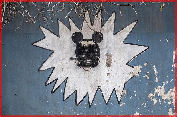This Sunday, Dec. 18, 2016 photo shows a drawing of Mickey Mouse with its face painted over by Islamic States militants on the wall of a kindergarten n the al-Barid district in Mosul, Iraq. In a part of Mosul that had been reclaimed from the Islamic State group (IS) days ago, Iraqi special forces were attacked on Sunday by drones operated by IS fighters inside the city.(AP Photo/Manu Brabo) (AP)