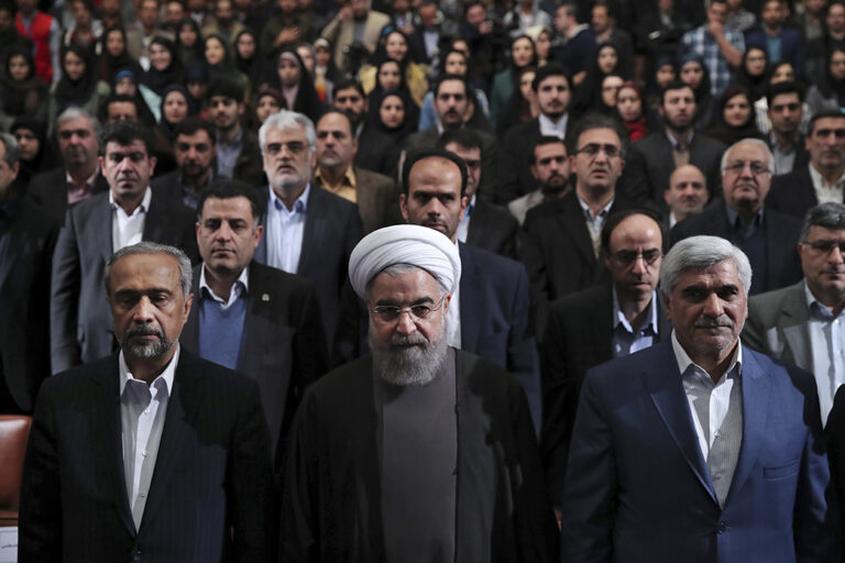 In this photo released by official website of the office of the Iranian Presidency, President Hassan Rouhani, center, Science Minister Mohammad Farhadi, right, and head of the President's office Mohammad Nahavandian, left, listen to the national anthem at the start of a ceremony marking Student Day at Tehran University in Tehran, Iran, Tuesday, Dec. 6, 2016. Rouhani said Tuesday his country will not allow incoming U.S. President Donald Trump to "tear up" Tehran's landmark nuclear deal with world powers. His remarks underscore Iranian leaders' attempts to calm concerns over the future of the deal in the wake of Trump's election. (Iranian Presidency Office via AP) (AP)