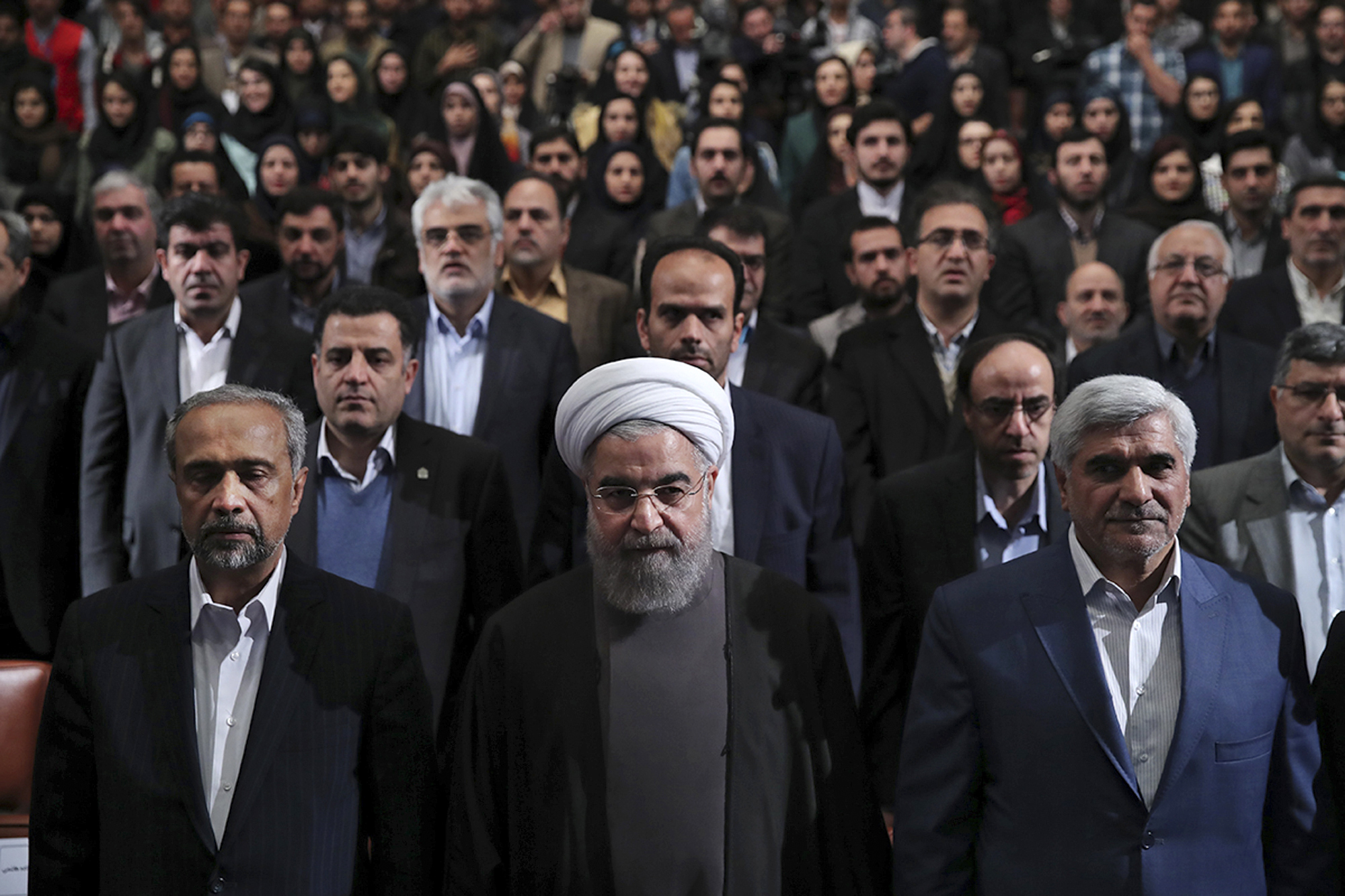In this photo released by official website of the office of the Iranian Presidency, President Hassan Rouhani, center, Science Minister Mohammad Farhadi, right, and head of the President's office Mohammad Nahavandian, left, listen to the national anthem at the start of a ceremony marking Student Day at Tehran University in Tehran, Iran, Tuesday, Dec. 6, 2016. Rouhani said Tuesday his country will not allow incoming U.S. President Donald Trump to "tear up" Tehran's landmark nuclear deal with world powers. His remarks underscore Iranian leaders' attempts to calm concerns over the future of the deal in the wake of Trump's election. (Iranian Presidency Office via AP) (AP)