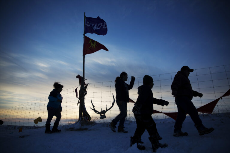 A Native American tribal flag stands atop a hill overlooking the Oceti Sakowin camp where people have gathered to protest the Dakota Access oil pipeline in Cannon Ball, N.D., Saturday, Dec. 3, 2016. (AP Photo/David Goldman) (AP)