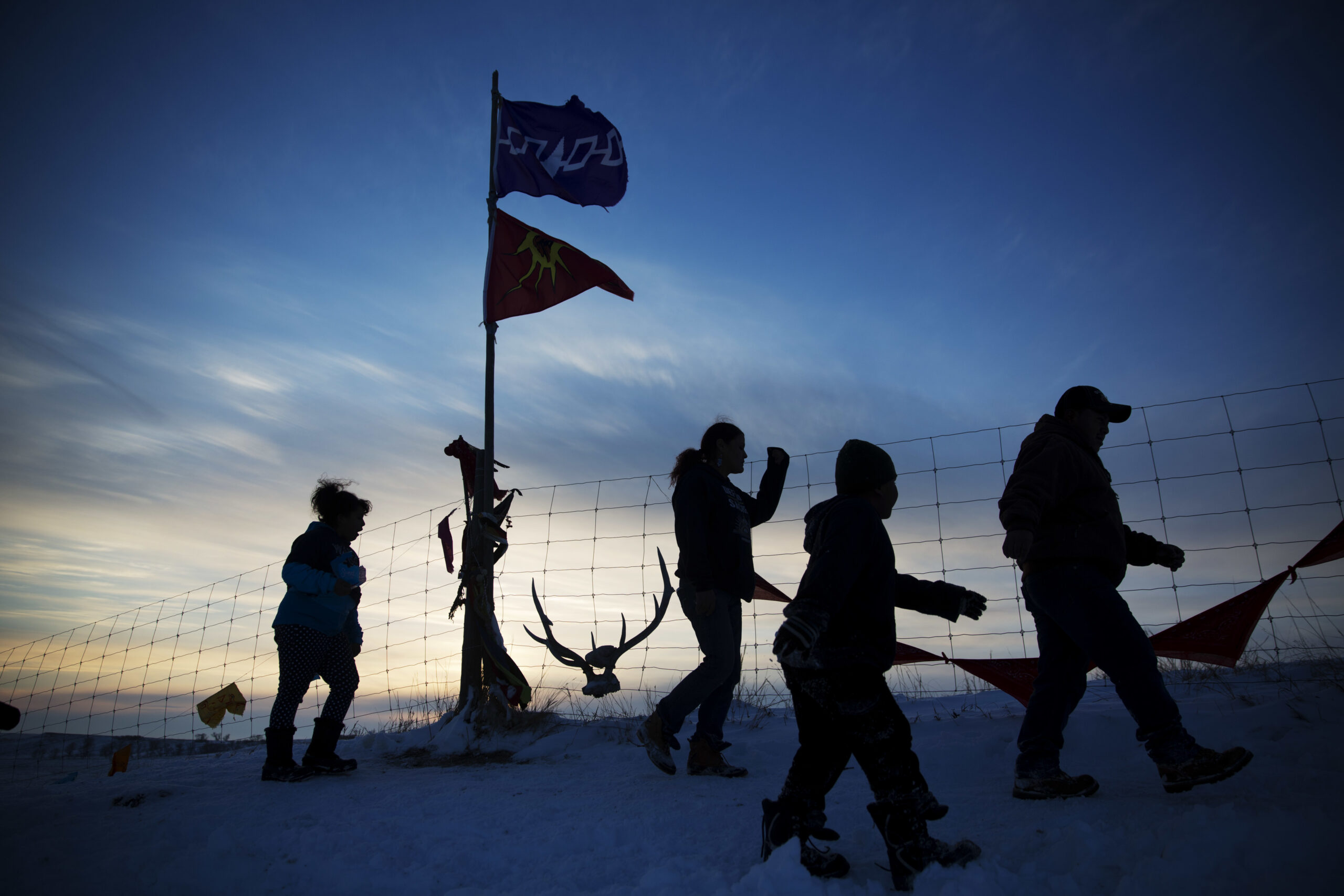 A Native American tribal flag stands atop a hill overlooking the Oceti Sakowin camp where people have gathered to protest the Dakota Access oil pipeline in Cannon Ball, N.D., Saturday, Dec. 3, 2016. (AP Photo/David Goldman) (AP)