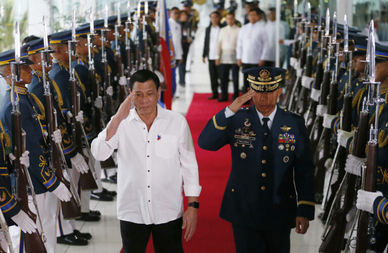 Philippine President Rodrigo Duterte salutes the honor guard prior to his departure for Cambodia and Singapore for official visits to the  ASEAN neighbors, Tuesday, Dec. 13, 2016 at the Ninoy Aquino International Airport in suburban Pasay city south of Manila, Philippines. Duterte said his trip to ASEAN neighbors is in preparation for the upcoming ASEAN summits which the Philippines is hosting late next year. (AP Photo/Bullit Marquez) (AP)