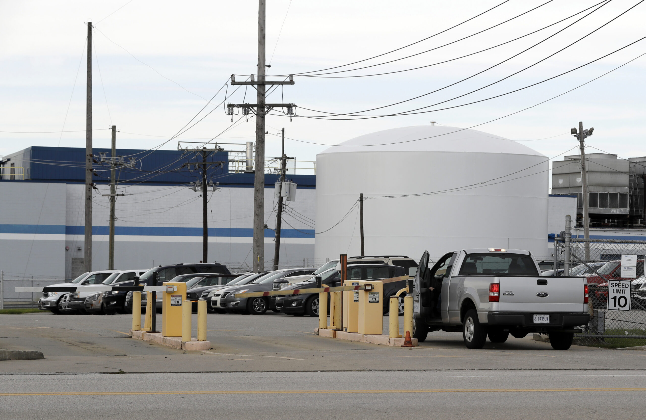 An employee enters the Carrier Corp. plant parking lot, Wednesday, Nov. 30, 2016, in Indianapolis. Carrier and President-elect Donald Trump reached an agreement to keep nearly 1,000 jobs in Indiana. Trump and Vice President-elect Mike Pence planned to travel to the state Thursday to unveil the agreement alongside company officials. (AP Photo/Darron Cummings) (AP)