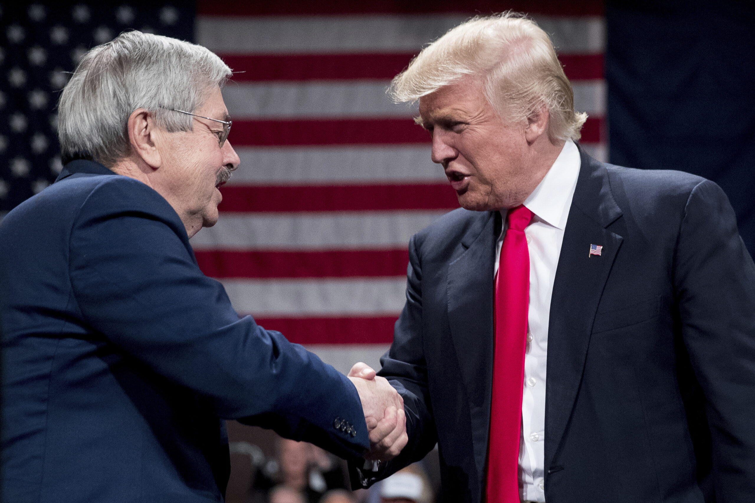 President-elect Donald Trump, right, greets Iowa Gov. Terry Branstad, left, as he welcomes him to the stage during a rally at Hy-Vee Hall, Thursday, Dec. 8, 2016, in Des Moines. Branstad has accepted Trump's offer to become U.S. ambassador to China. (AP Photo/Andrew Harnik) (AP)