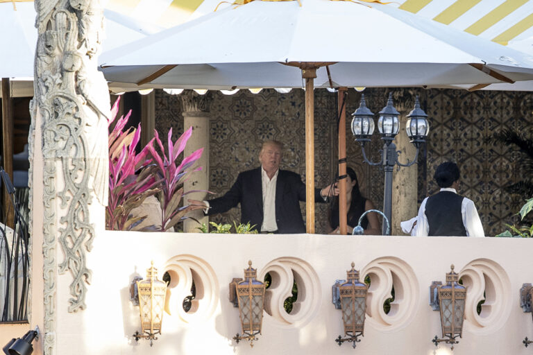 President-elect Donald Trump, center, speaks to an aide at Mar-a-Lago resort, in Palm Beach, Fla., Monday, Dec. 19, 2016. (AP)