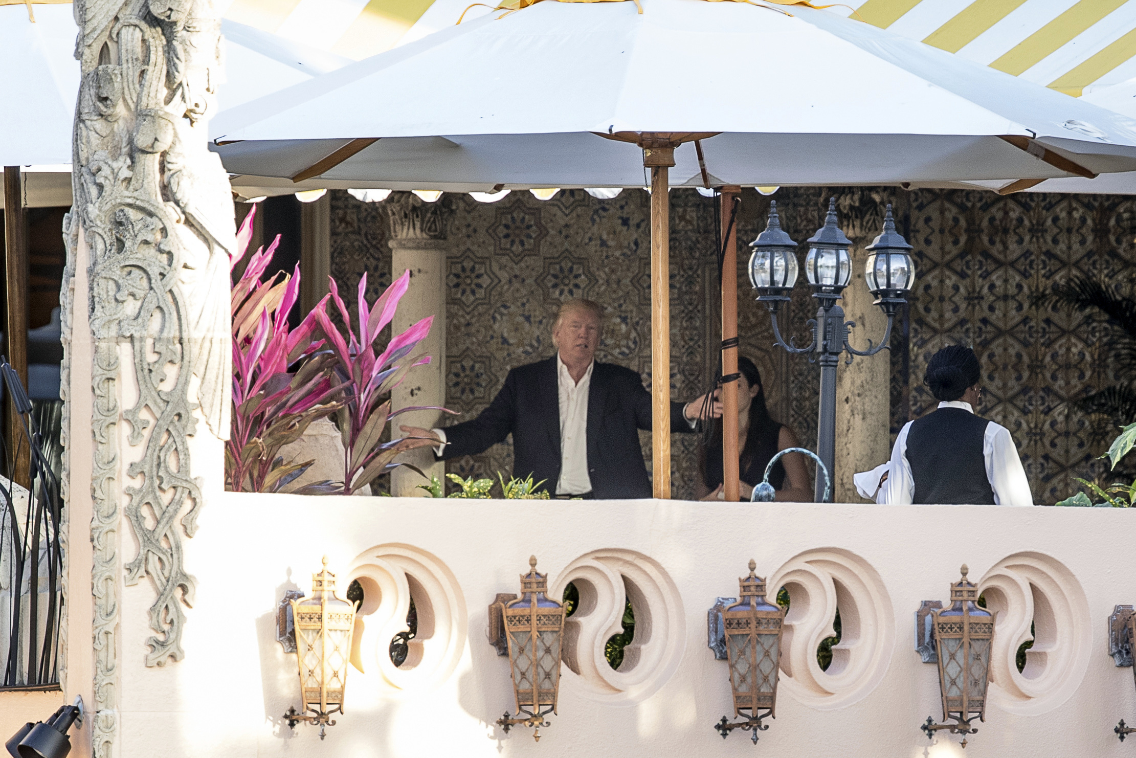 President-elect Donald Trump, center, speaks to an aide at Mar-a-Lago resort, in Palm Beach, Fla., Monday, Dec. 19, 2016. (AP)
