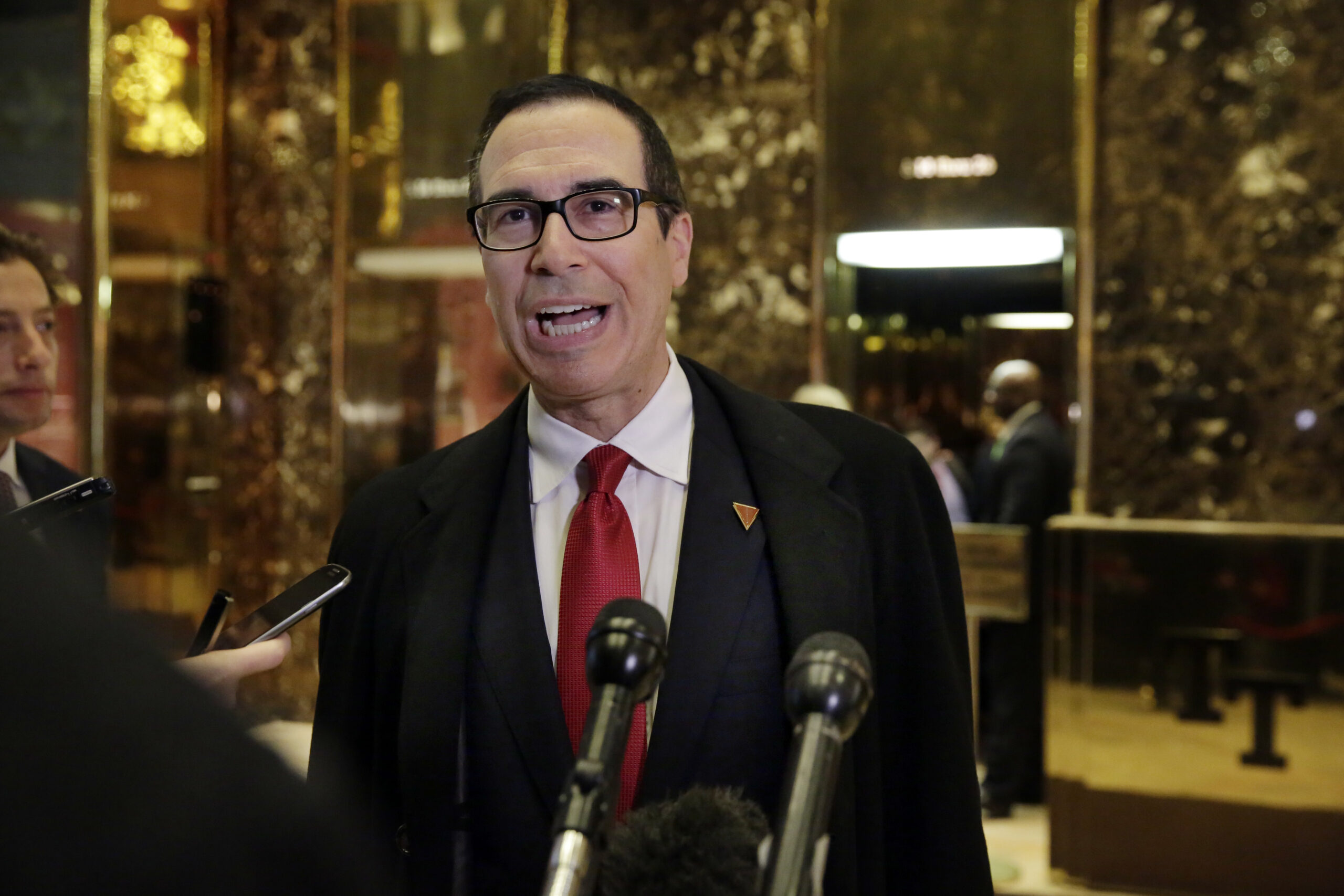 FILE - In this Nov. 30, 2016 file photo, Treasury Secretary-designate Steven Mnuchin talks to reporters as he arrives at Trump Tower in New York.  There's growing concern among Republicans about the upcoming Senate confirmation hearings Mnuchin, the Wall Street financier Donald Trump has chosen to head the Treasury Department (AP Photo/Richard Drew, File) (AP)
