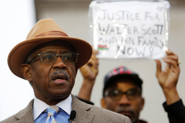 The Rev. Nelson B. Rivers III speaks during a prayer vigil in front of the Charleston County Courthouse as the jury deliberates in the Michael Slager trial Monday, Dec. 5, 2016, in Charleston, S.C. (AP/Mic Smith)