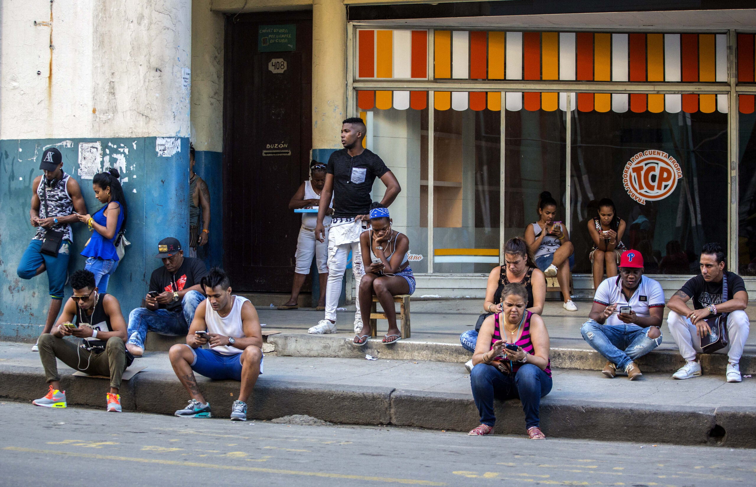 In this Jan. 6, 2017 photo, people use a public wifi hotspot in Havana, Cuba. Home internet came to Cuba in December 2016, in a limited pilot program that’s part of the most dramatic change in daily life here since the declaration of detente with the United States on Dec. 17, 2014. (AP Photo/Desmond Boylan) (AP)