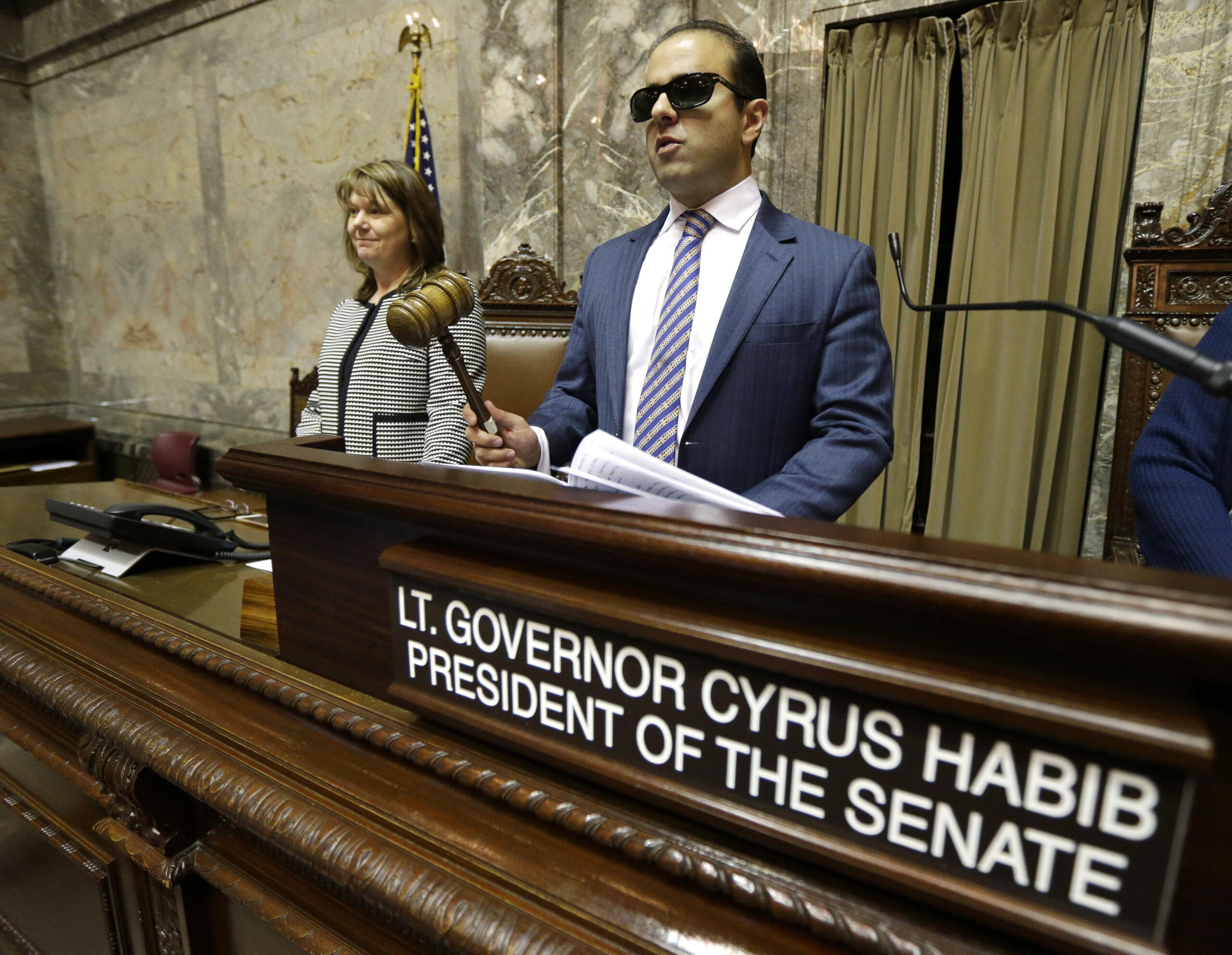 Washington Lt. Gov.-elect Cyrus Habib, right, holds the gavel as he stands at the Senate chamber dais next to Senate Counsel Jeannie Gorrell, left, Thursday, Jan. 5, 2017. (AP Photo/Ted S. Warren) (AP)