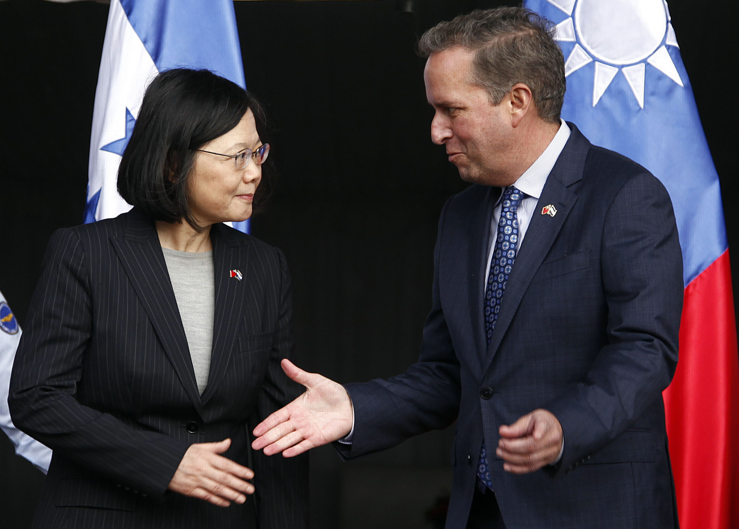 CORRECTS SPELLING OF GUATEMALA - Taiwan's President Tsai Ing-wen, left, shakes hands with First Vice President of Honduras Ricardo Alvarez after arriving at Soto Cano Air Base outside Comayagua, Honduras, Sunday, Jan. 8, 2017. The Taiwanese leader will meet with Honduran President Juan Orlando Hernandez on Monday, as part of a weeklong state tour to reinforce Taiwanese relations with Honduras, Guatemala, El Salvador, and Nicaragua. (AP Photo/Fernando Antonio) (AP)