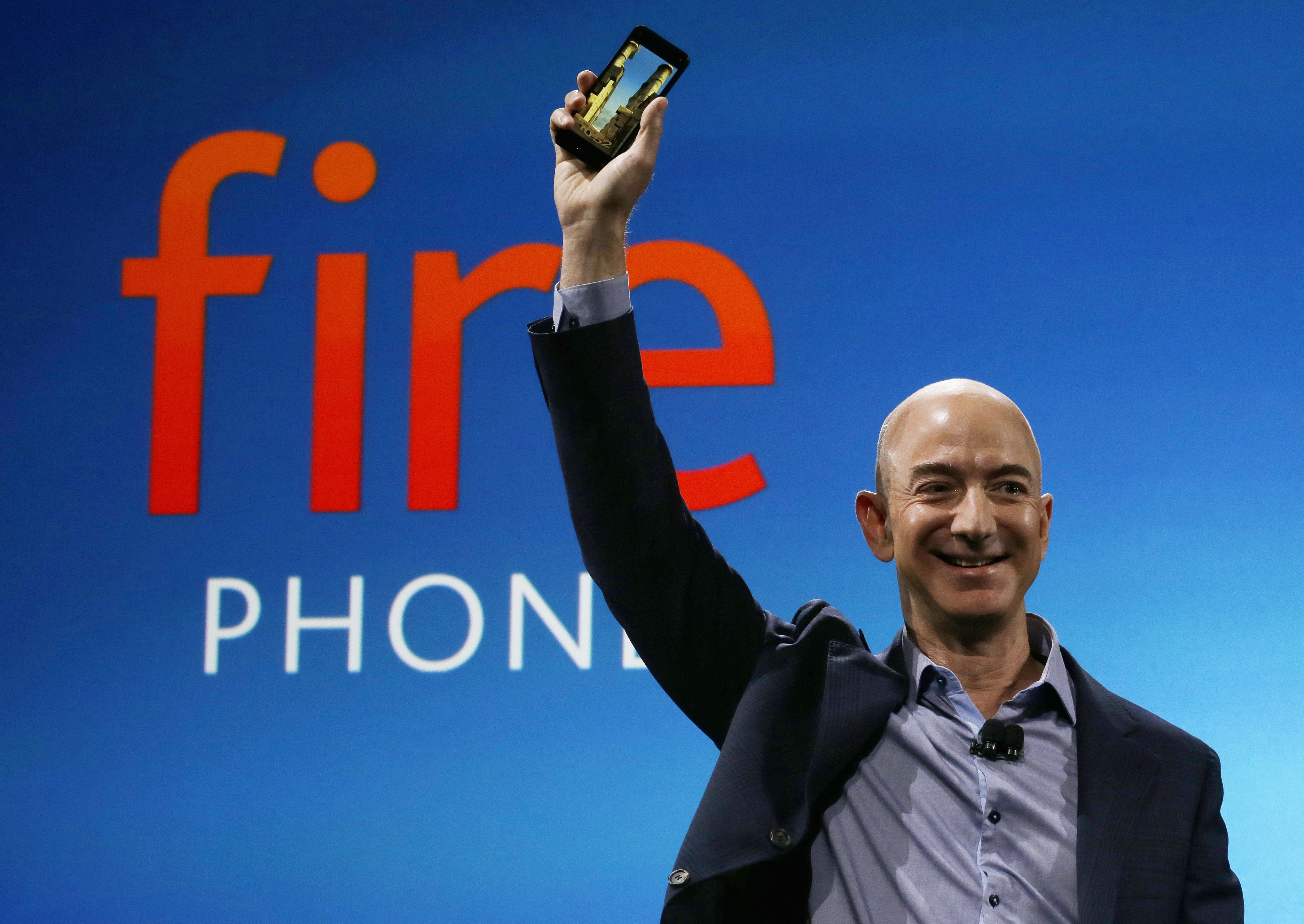 FILE - In this June 18, 2014 file photo, Amazon CEO Jeff Bezos introduces the new Amazon Fire Phone in Seattle. The eight individuals who own as much as half of the rest of the planet are all men, and have largely made their fortunes in technology. The founder and CEO of Amazon.com helped revolutionize the retail industry by popularizing online shopping. (AP Photo/Ted S. Warren, File) (AP)