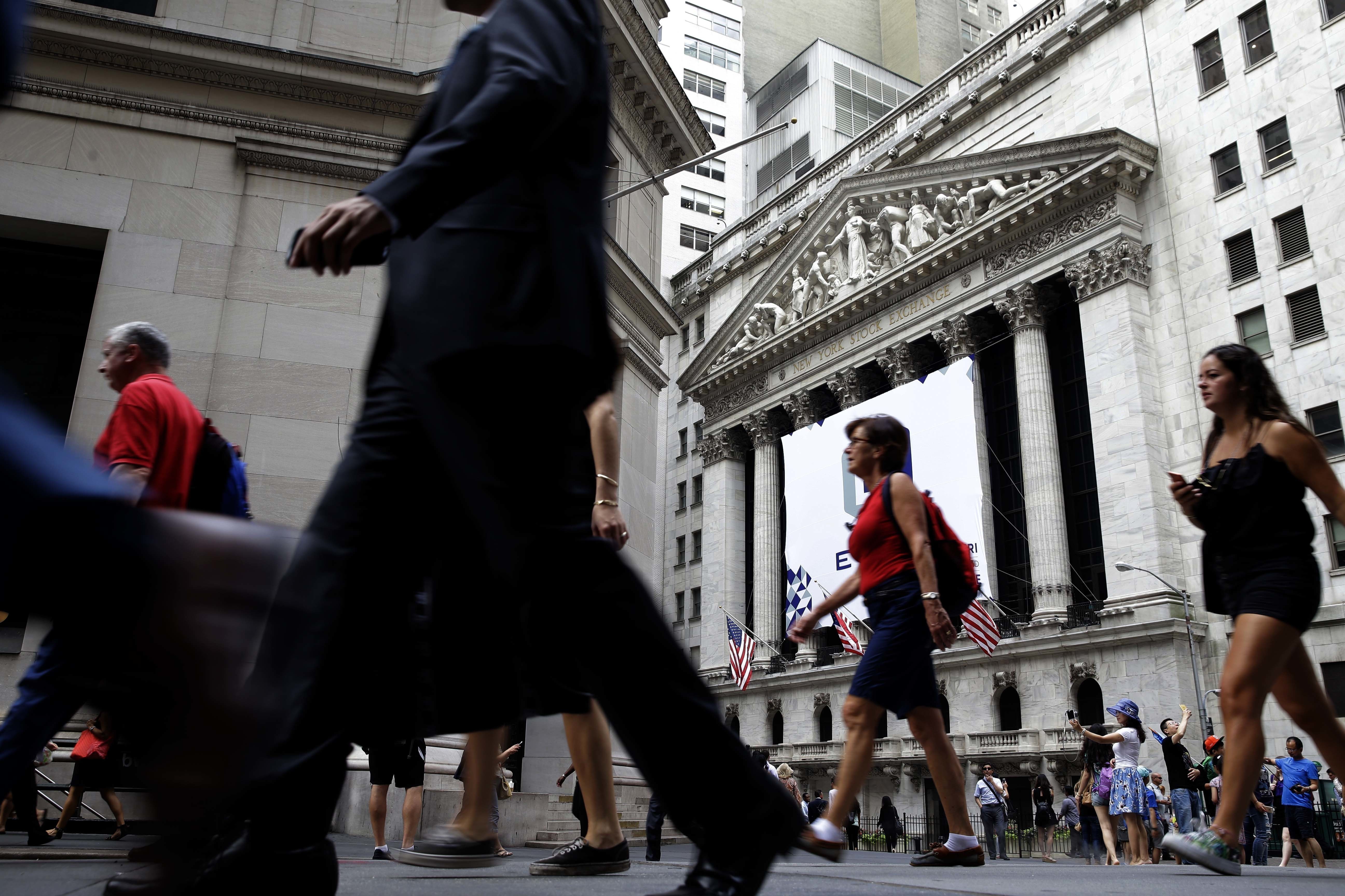 FILE - In this Monday, Aug. 24, 2015, file photo, pedestrians walk past the New York Stock Exchange. While Wall Street celebrates yet another stock market record, surpassing 20,000 on the Dow Jones industrial average on Wednesday, Jan. 25, 2017, most of America has little reason to cheer. The wealthiest one-tenth of Americans owns 80 percent of stock market wealth. (AP Photo/Seth Wenig, File) (AP)
